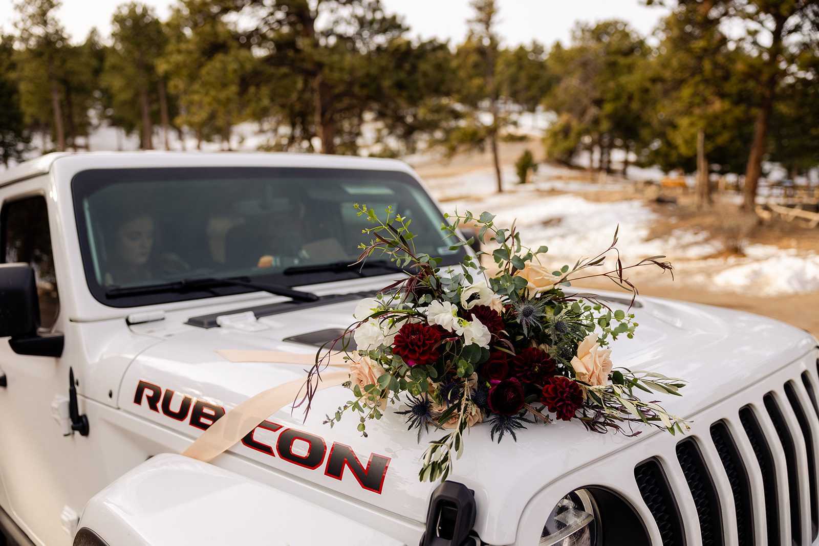 The bridal bouquet on top of a jeep after the Lost Gulch elopement with  videography.