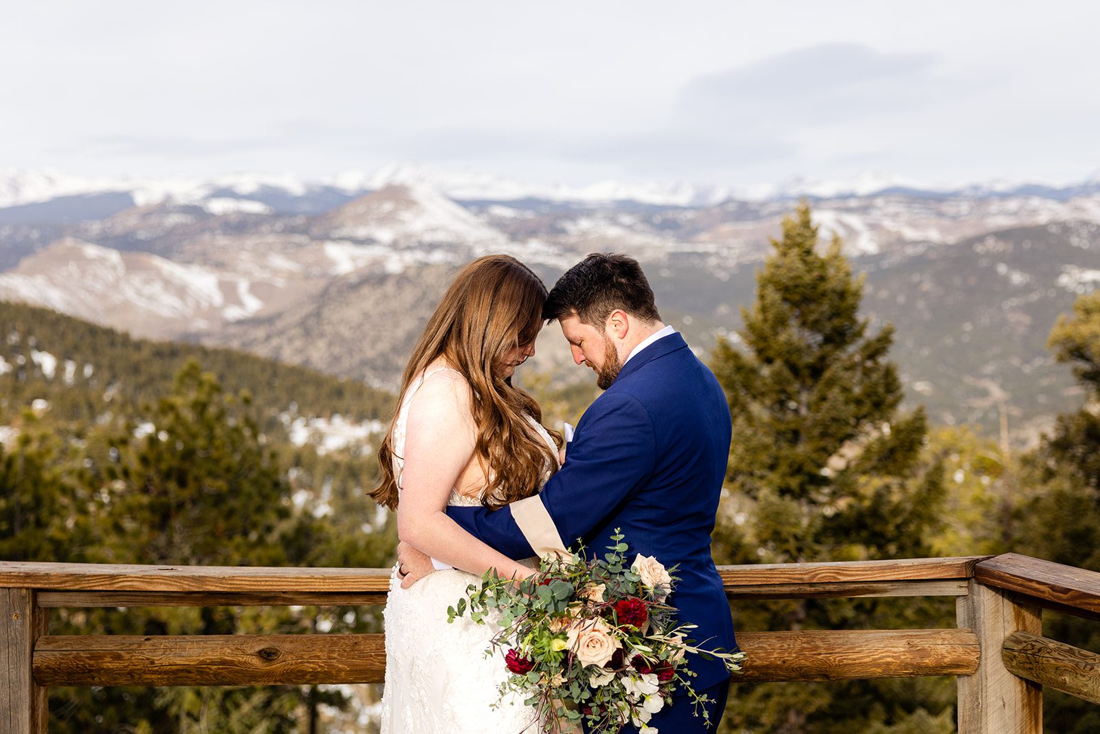 bride and groom cuddle sweetly, head to head, after their Lost Gulch elopement with  videography.