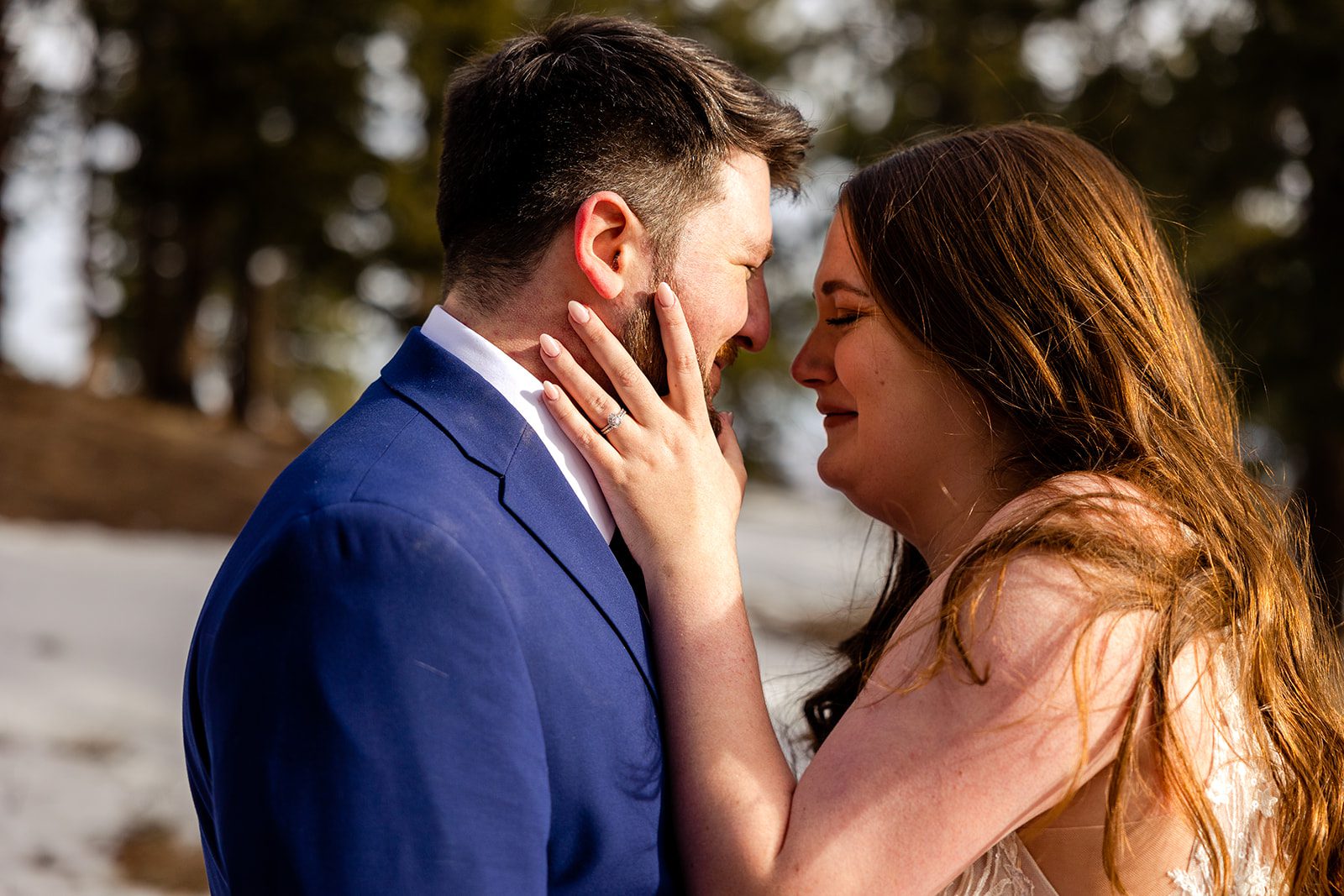bride holds her grooms face, crying softly after their Lost Gulch elopement with  videography.