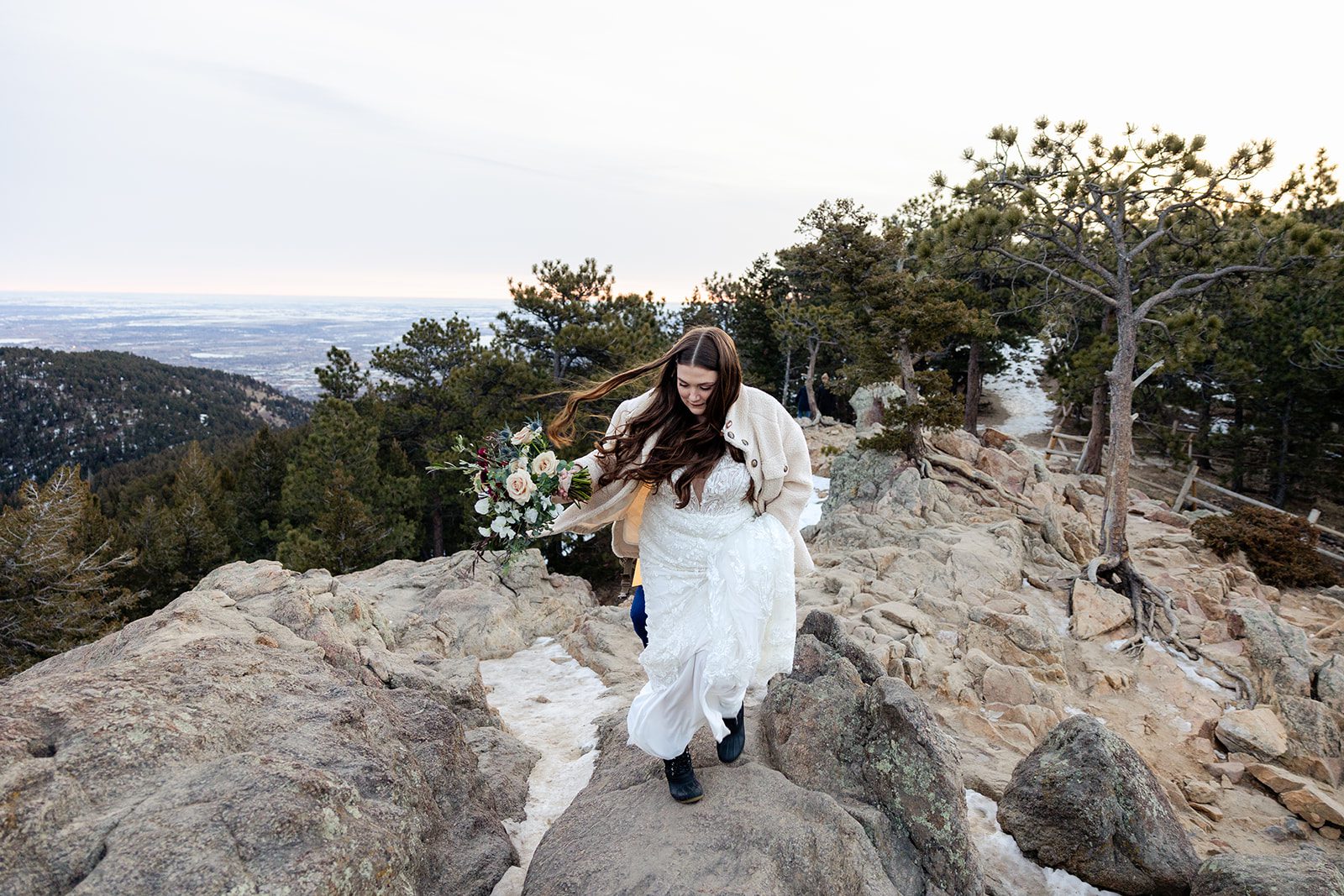 bride hiking up the mountain at their Lost Gulch elopement with  videography.