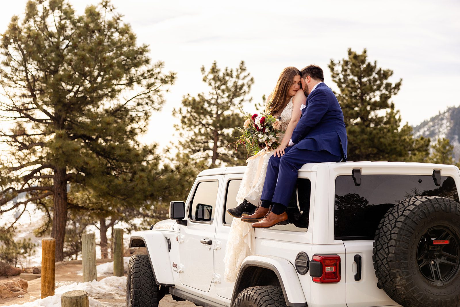 bride and groom close together on top of the jeep after their Lost Gulch elopement with  videography.