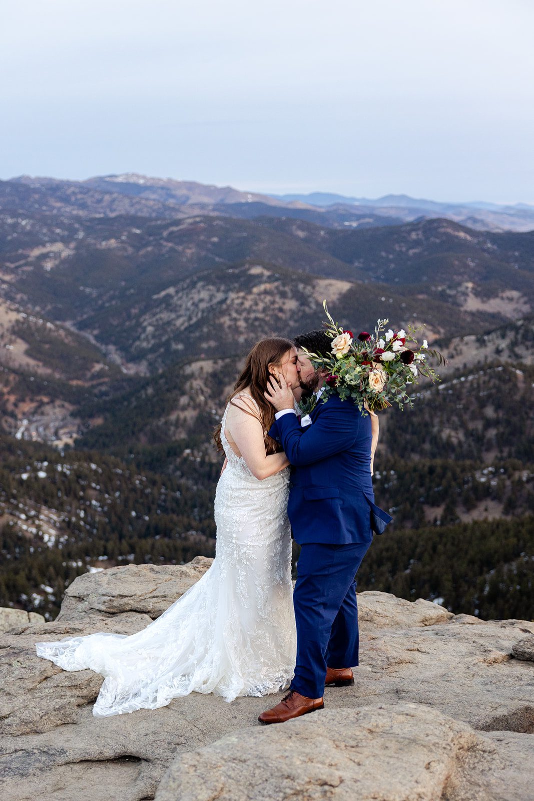 bride and groom kissing on top of Lost Gulch during their elopement with videography.