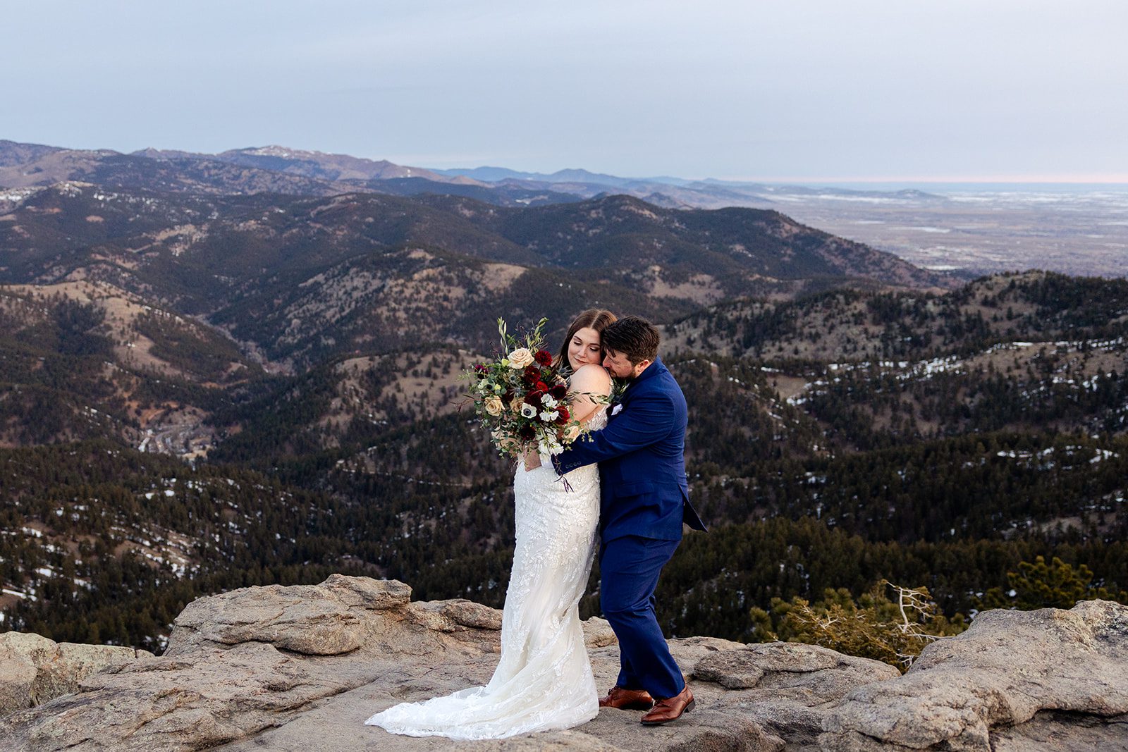 Groom wraps his arms around his bride during their Lost Gulch elopement with  videography.