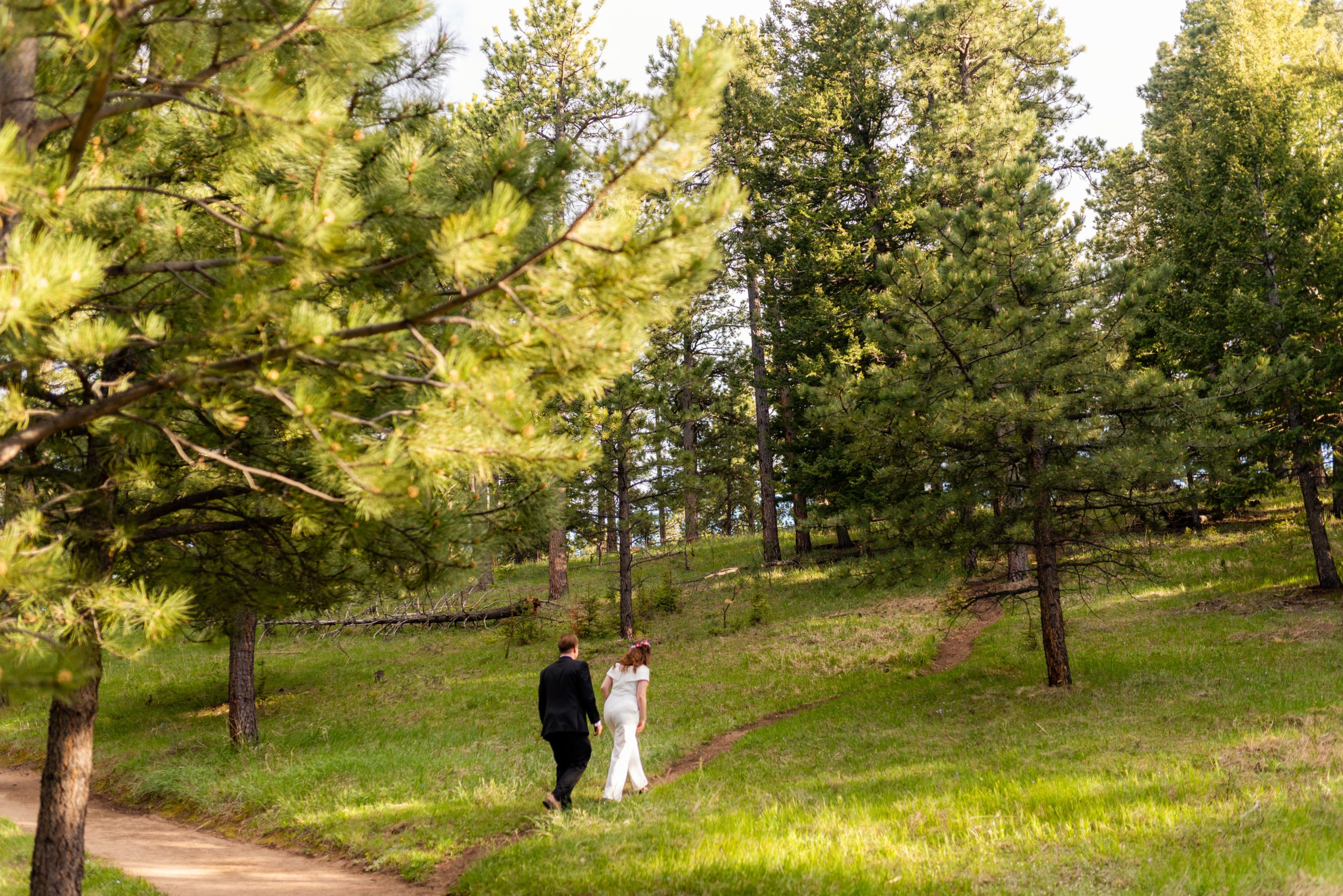 The bride and groom walking the trail during their Boulder hiking elopement near realization point..