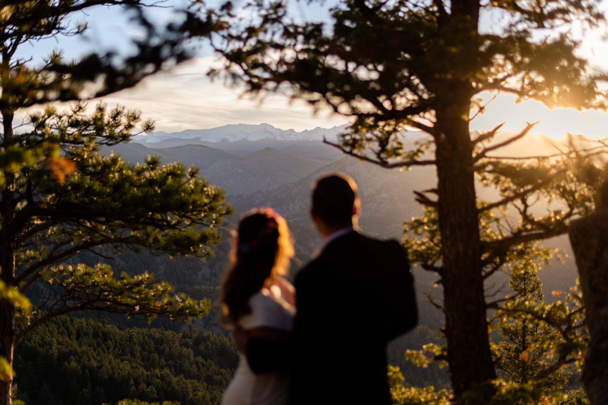 The bride and groom admiring the sunset during their Boulder Hiking elopement near Realization point. 
