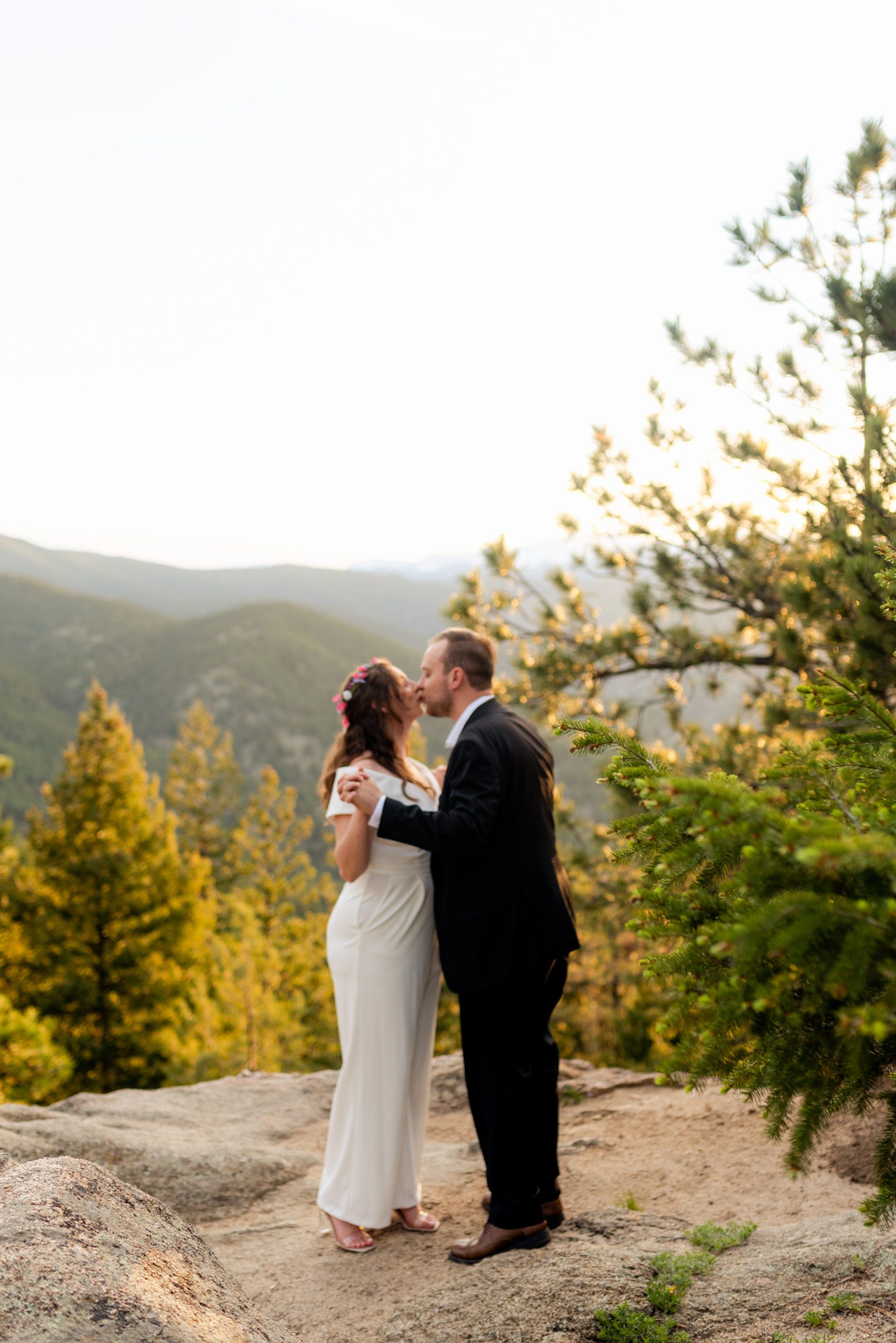 The bride and groom kissing during their Boulder Hiking elopement near Realization point. 