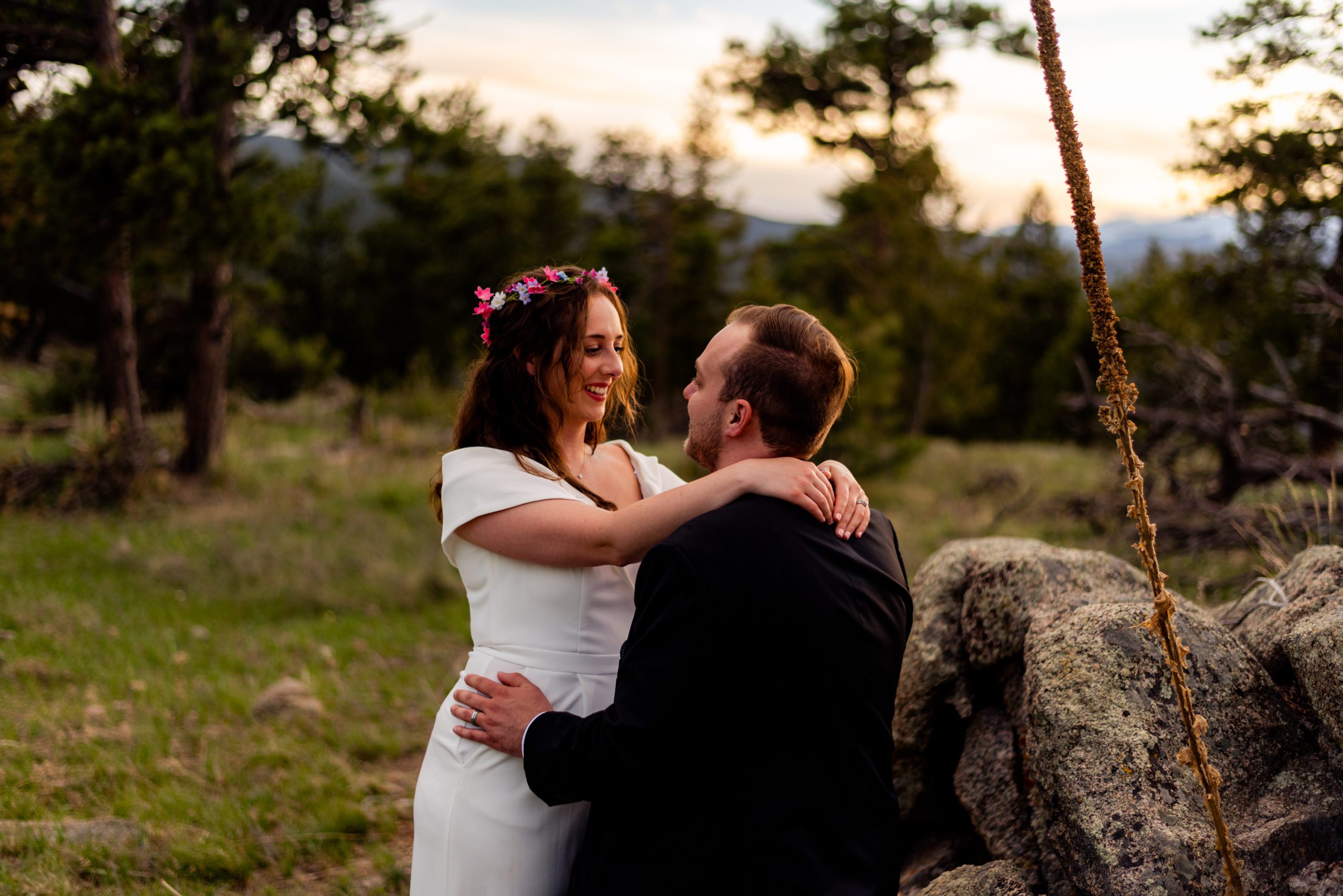 The bride smiles at her new husband as the sunset during their Boulder Hiking elopement near Realization point. 