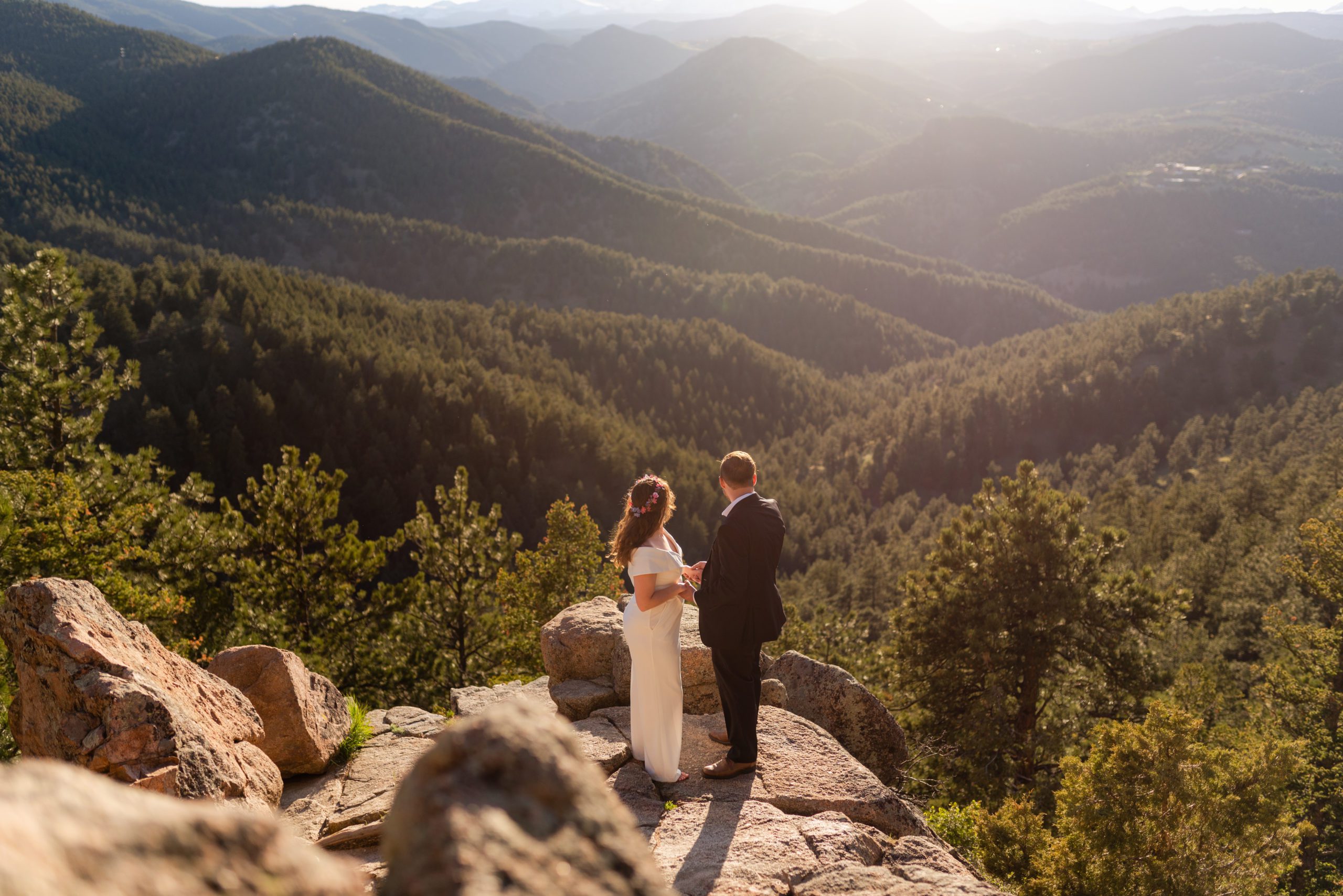 The bride and groom look out into the valley below during their Boulder hiking elopement near realization point.