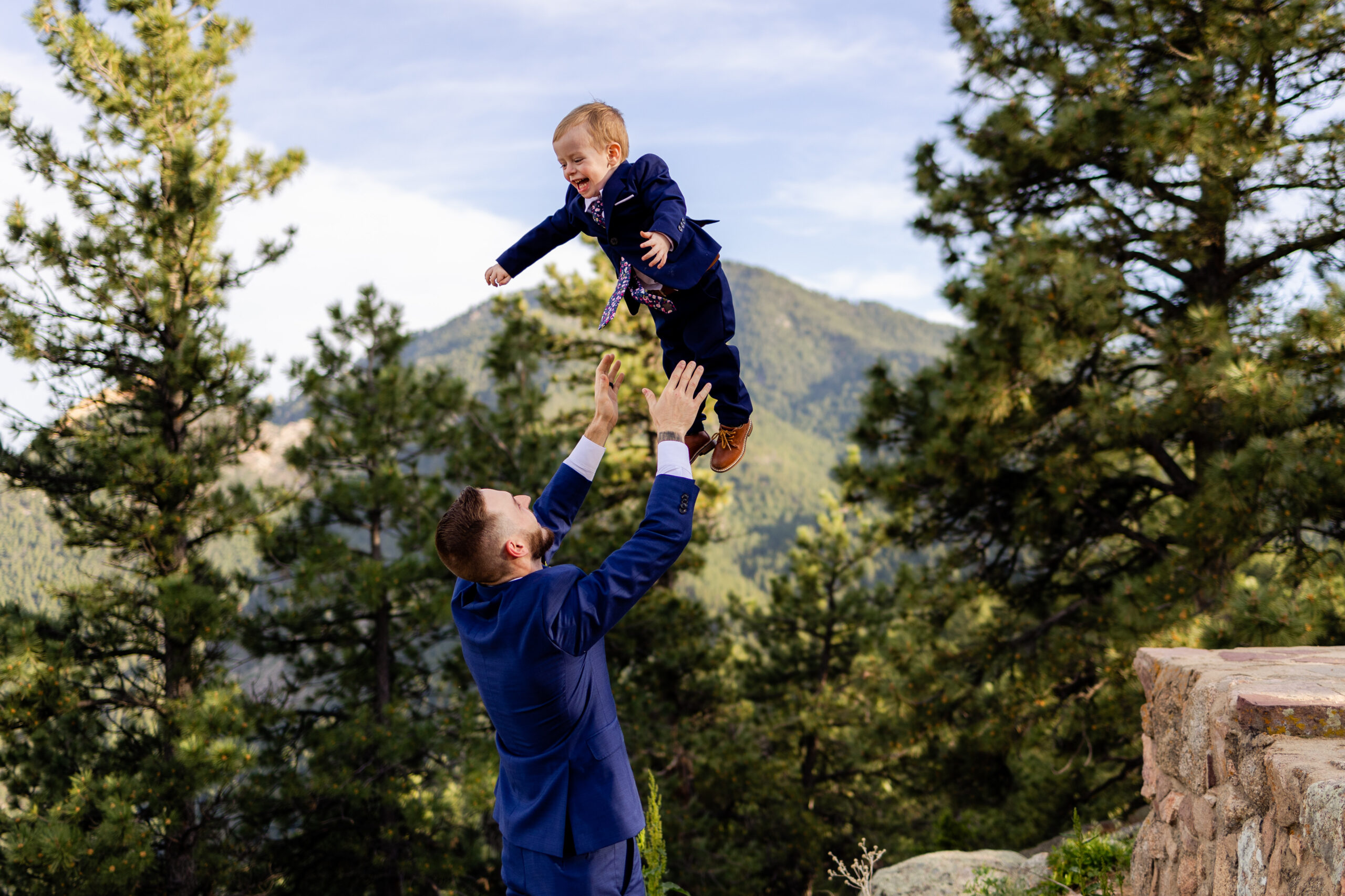 The groom throws his son in the air at Sunrise Amphitheater during their Elopement.