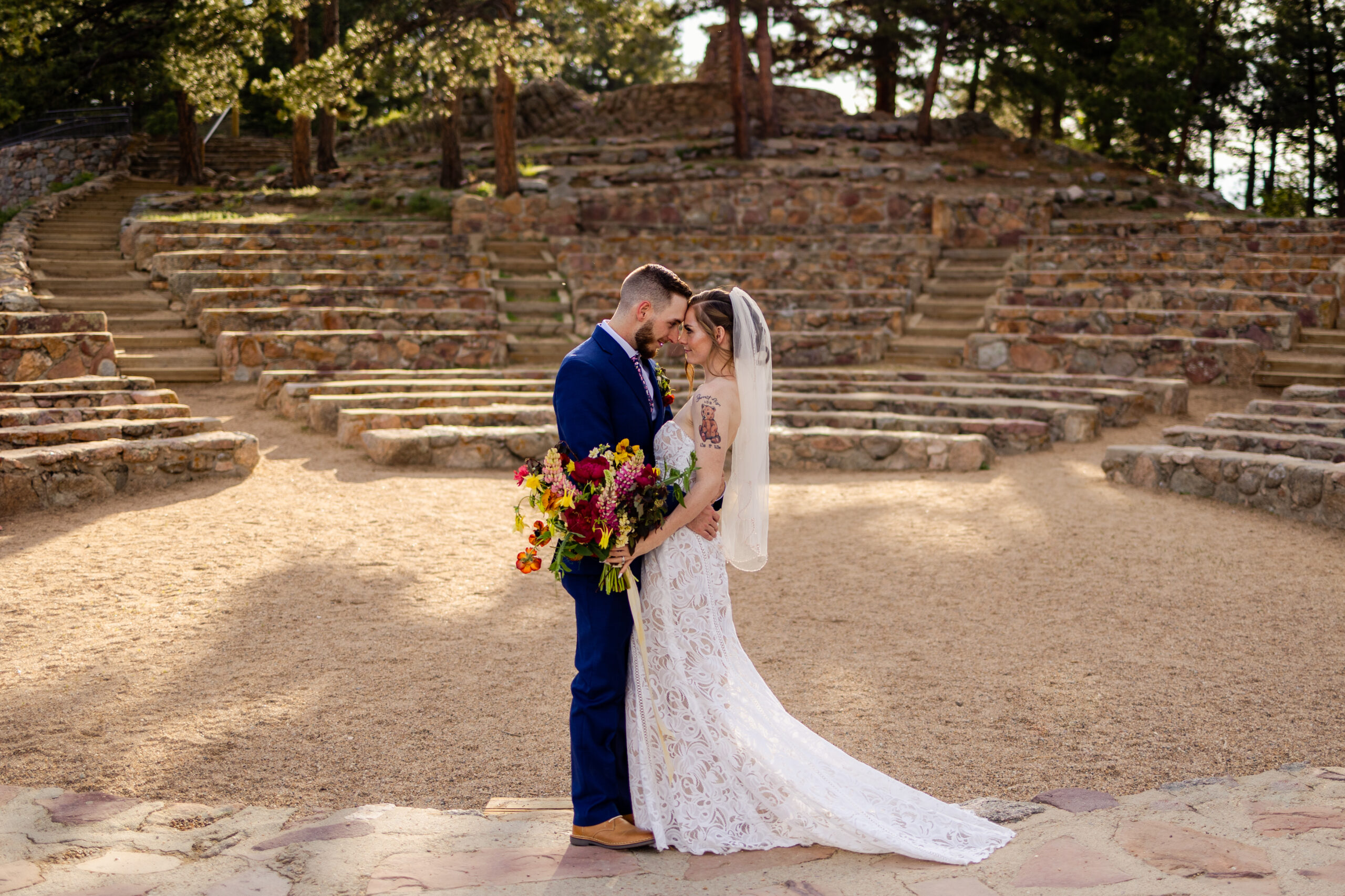 The bride and groom forehead to forehead in the  Sunrise amphitheater on their elopement day.