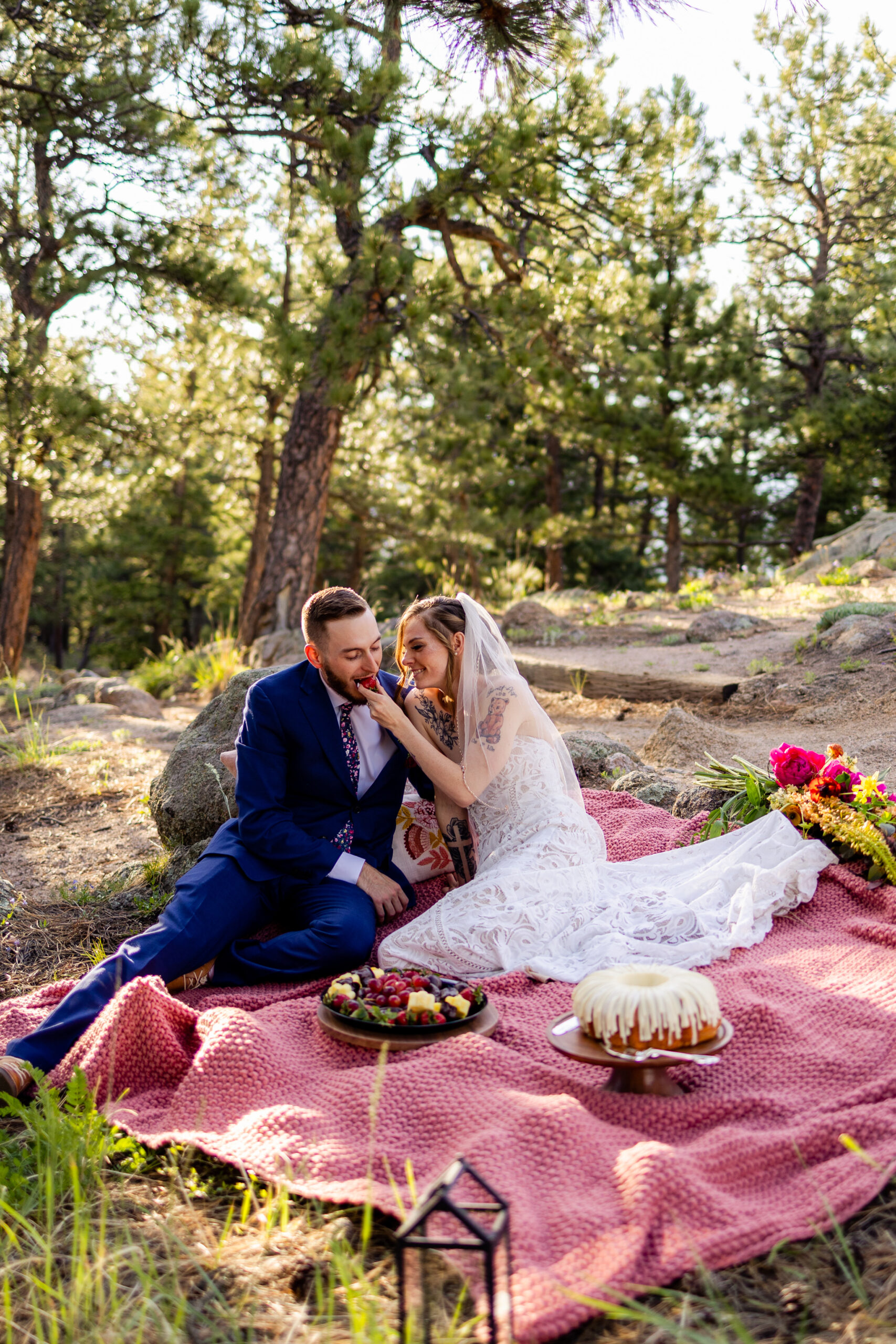 The bride feeding her groom a strawberry during their picnic at Artist Point after their Sunrise Amphitheater elopement ceremony. 