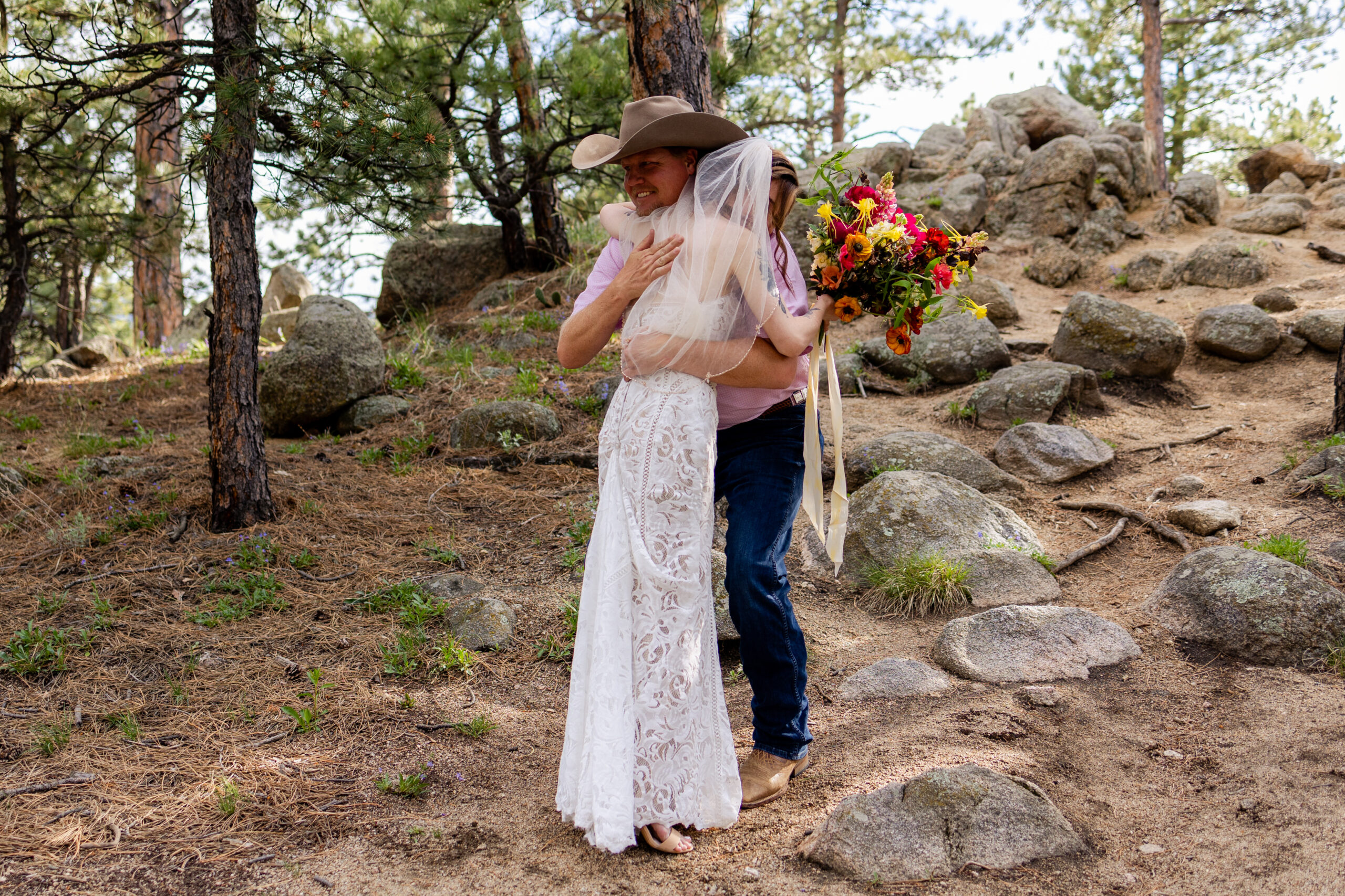 The bride hugging her dad after they shared a first look at at Sunrise Amphitheater for her Artist Point Elopement.