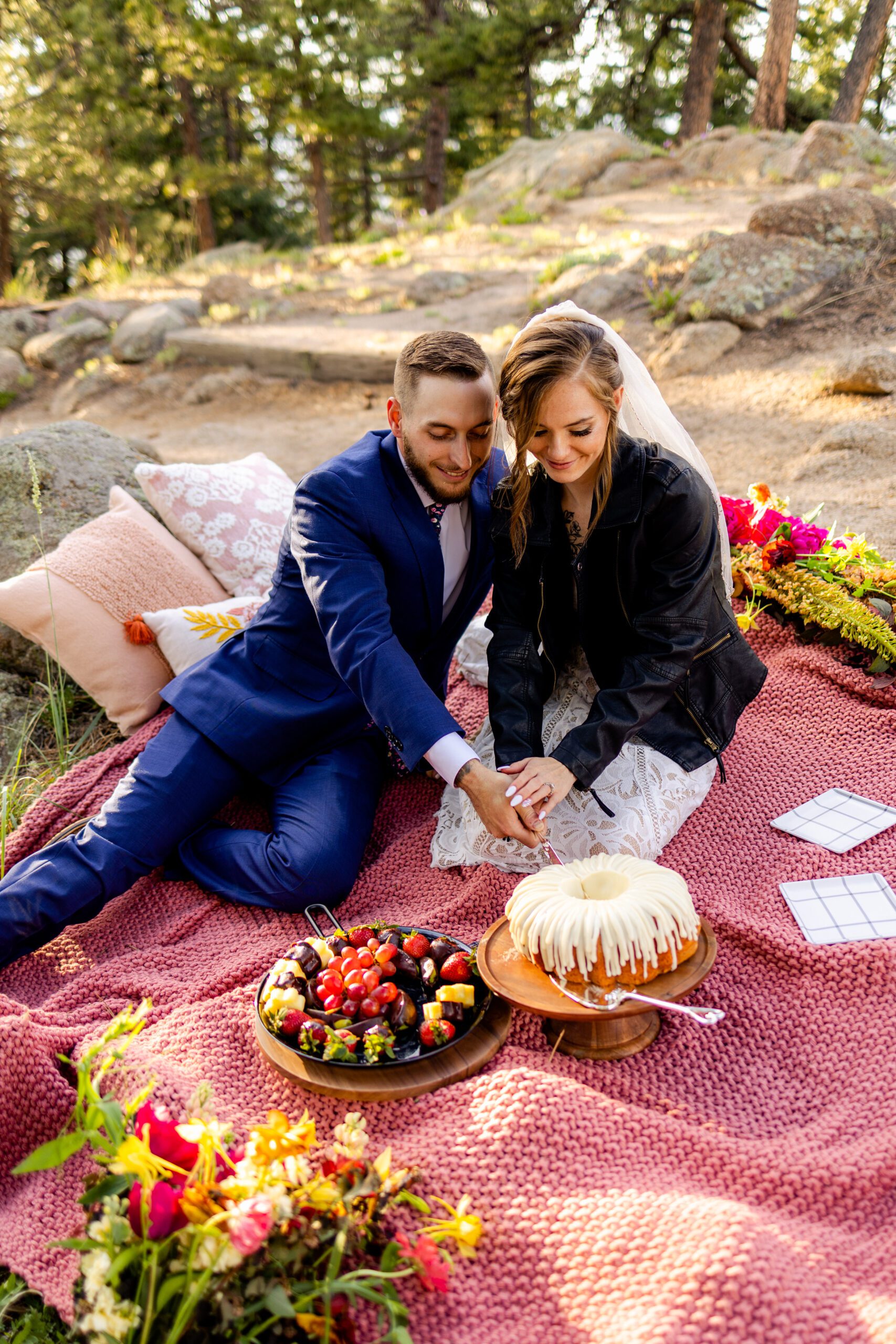 The bride and groom cutting their cake at their picnic at Artist Point after their Sunrise Amphitheater elopement ceremony. 