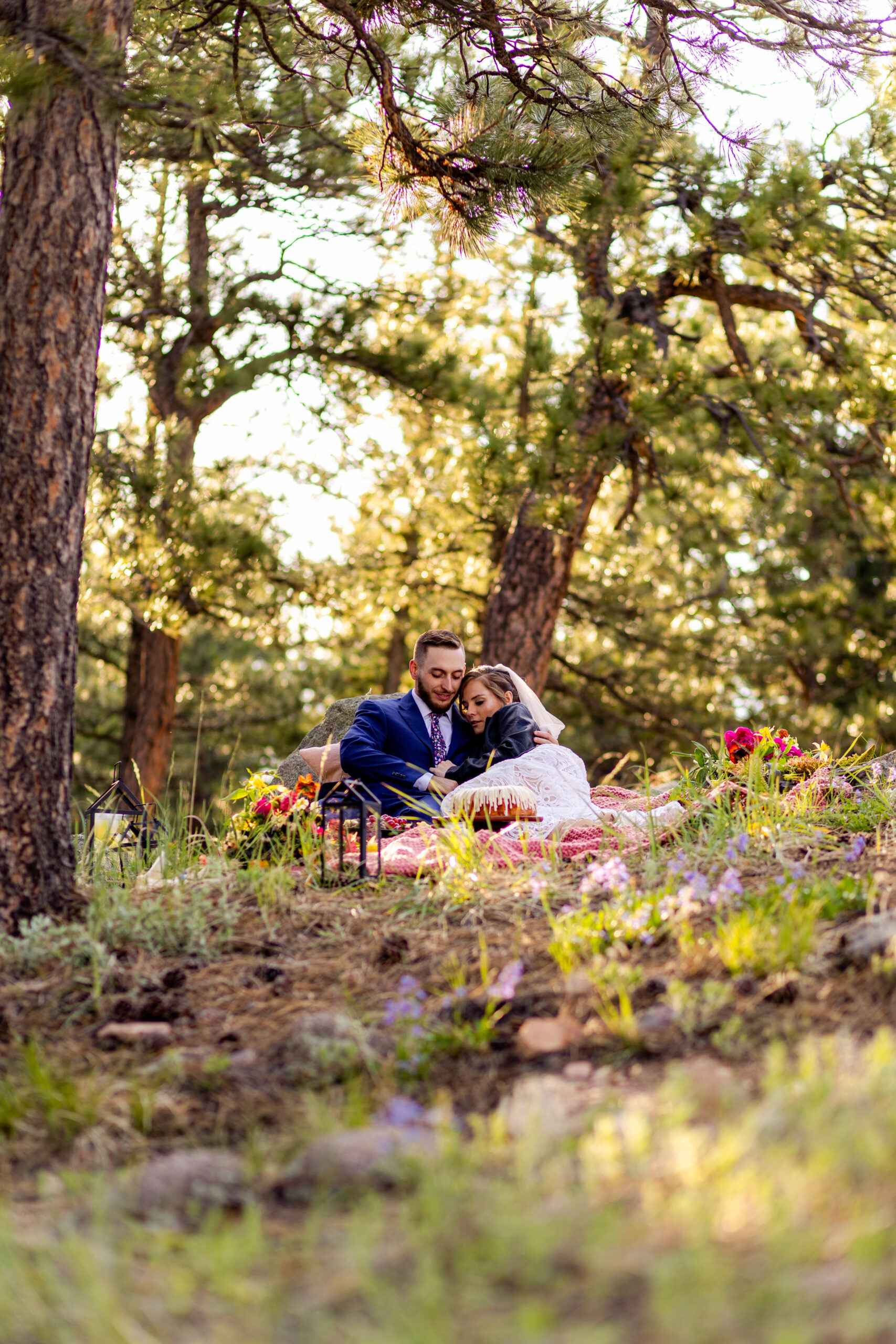 A photo of the bride and groom cuddling at their post-elopement picnic at Artist Point after their Sunrise Amphitheater elopement ceremony. 