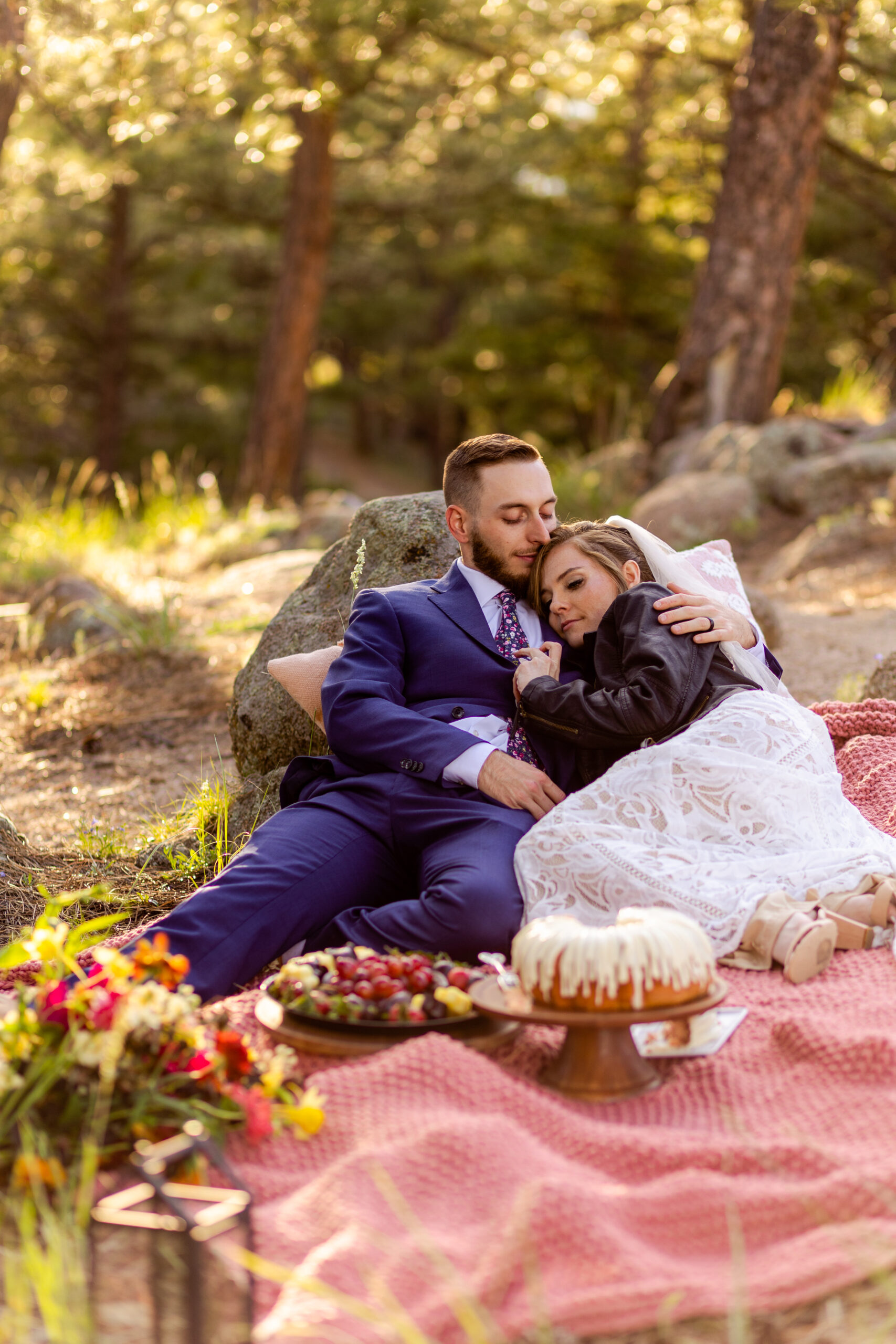 The bride lays her heads on her grooms chest during their post-elopement picnic at Artist Point after their Sunrise Amphitheater elopement ceremony. 