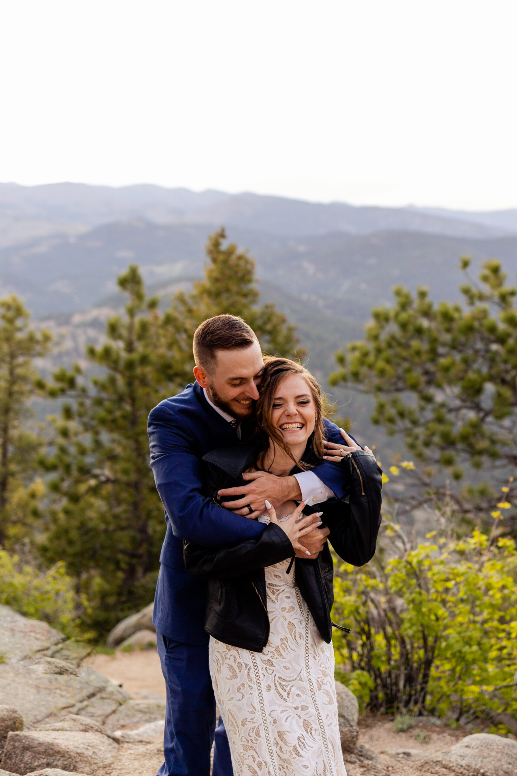 The groom wraps his arms around his new  bride at Artist Point after their Sunrise Amphitheater elopement ceremony. 