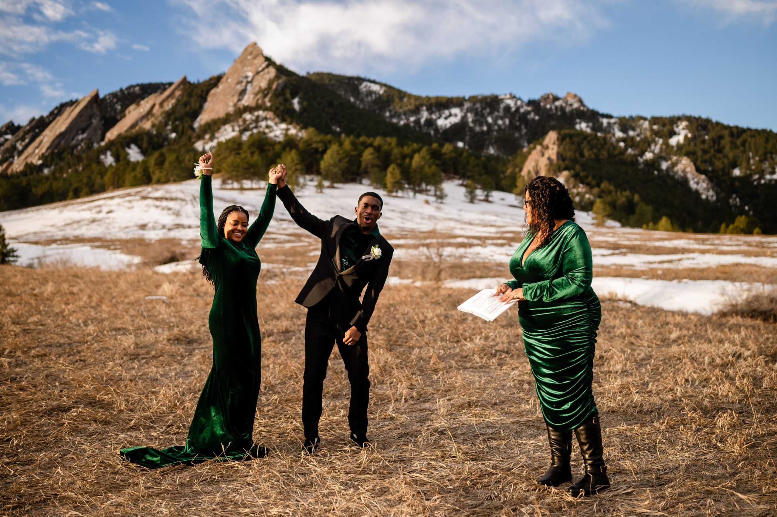 the groom and bride cheering with their arms in the air after their Chautauqua Trail elopement ceremony. 