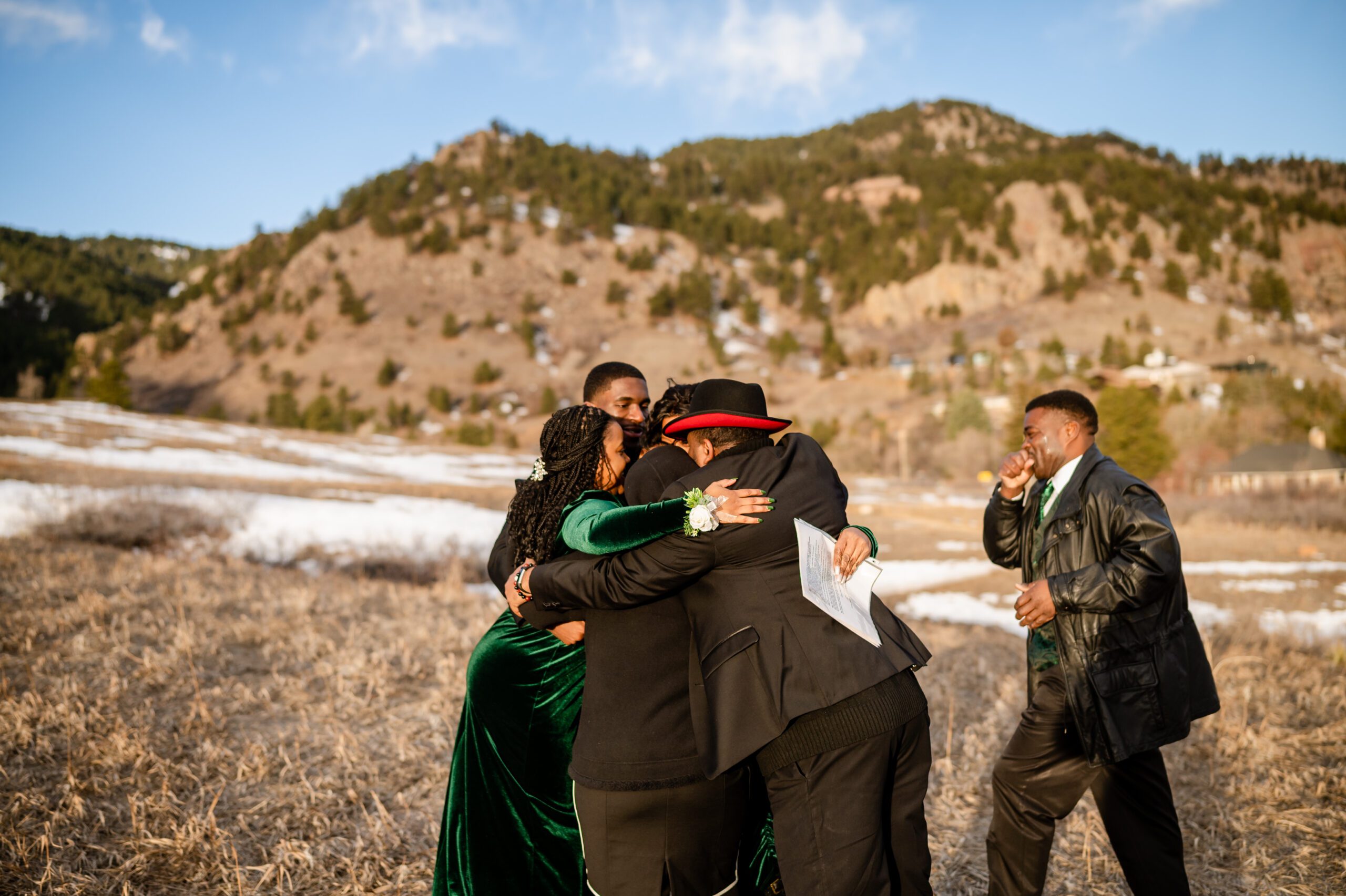 the families come together, wrapped in each other's arms for a big hug, after the Chautauqua Trail elopement ceremony.