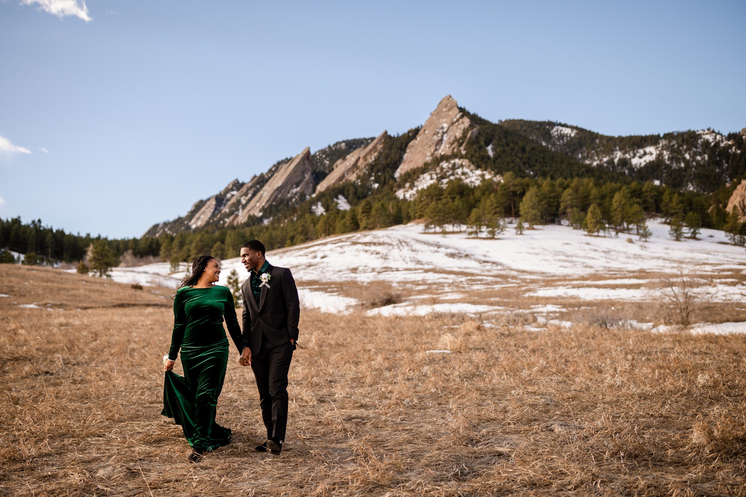 bride and groom holding hands, smiling at each other at their Chautauqua Trail elopement.