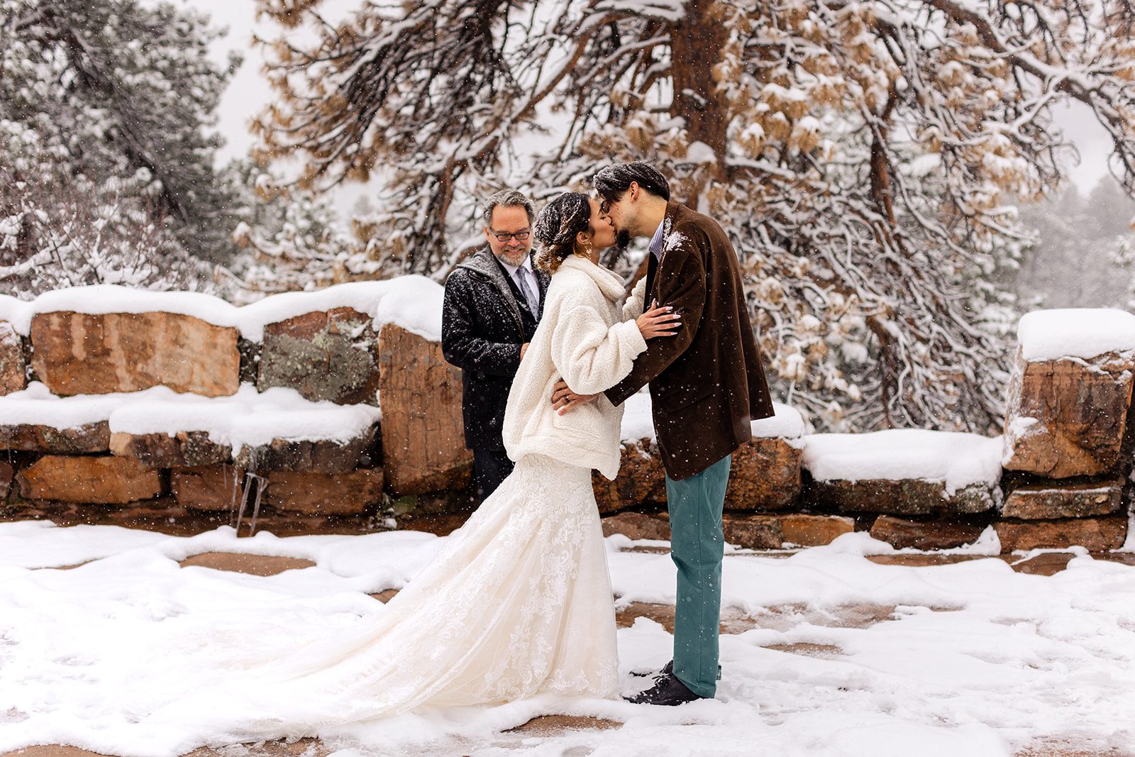 bride and groom kiss in the snow during their Halfway House elopement ceremony.