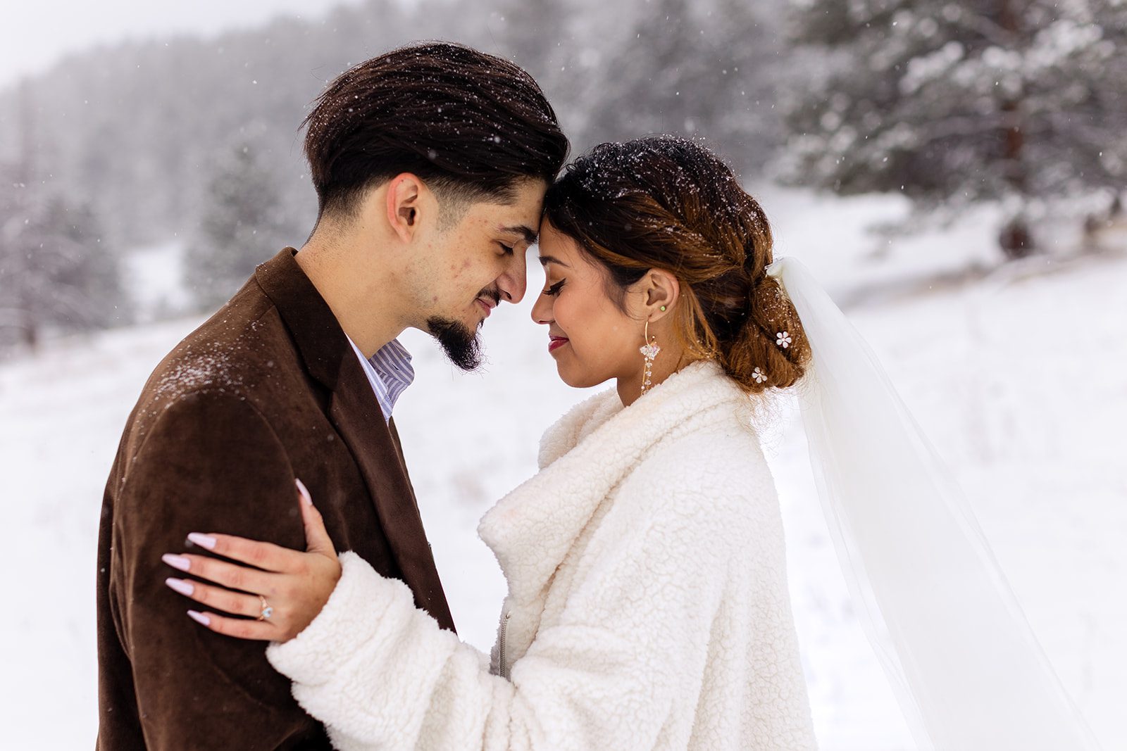 newlyweds on a snowy spring day after their halfway house elopement ceremony