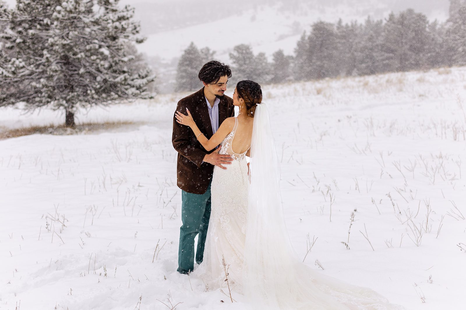 bride and groom on Flagstaff Mountain on a snowy spring day after their halfway house elopement ceremony