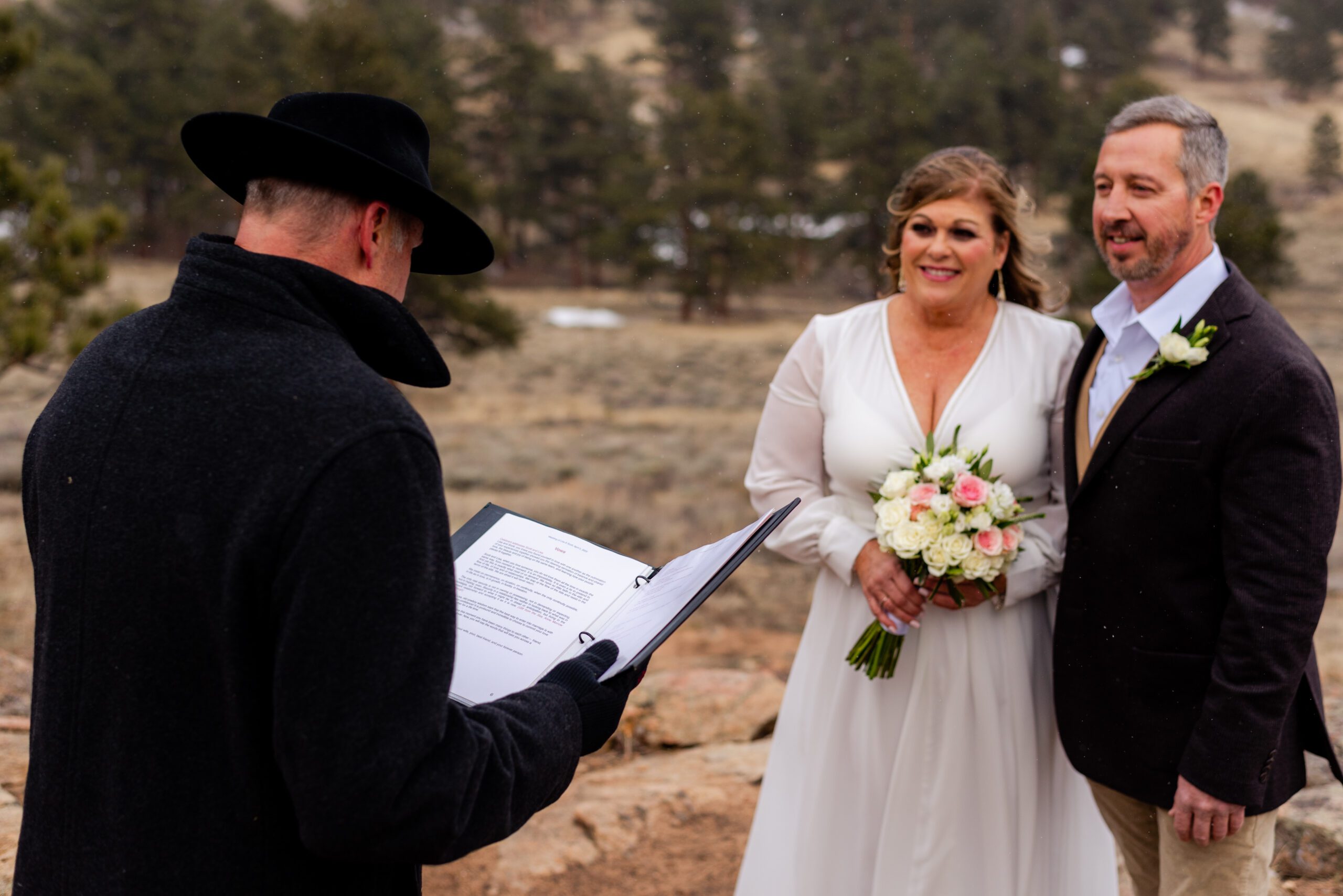 the bride and groom looking at the officiant guiding their spring elopement at 3M Curve.