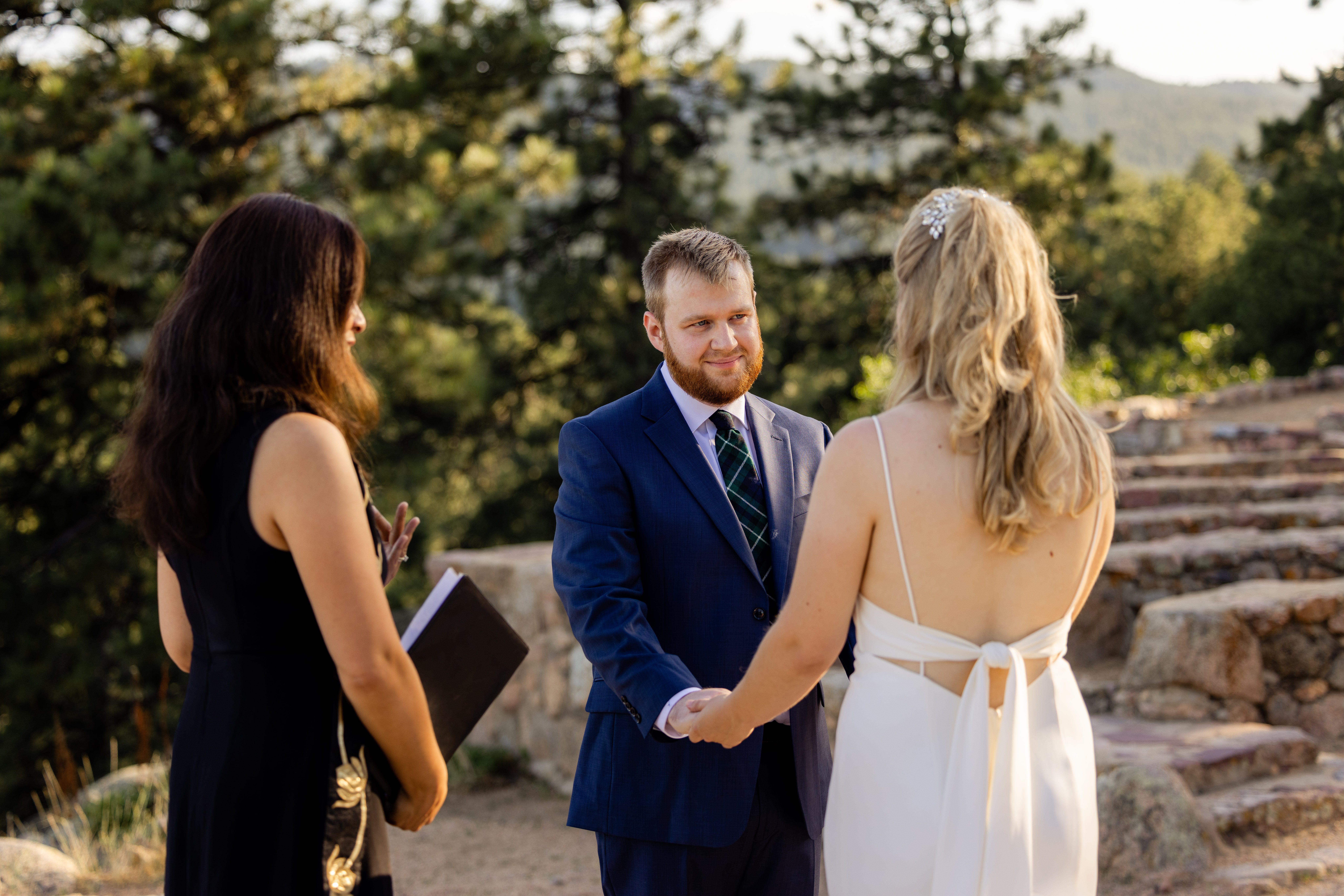 the groom looks at his beautiful bride during their ceremony for their Sunrise Amphitheater wedding.