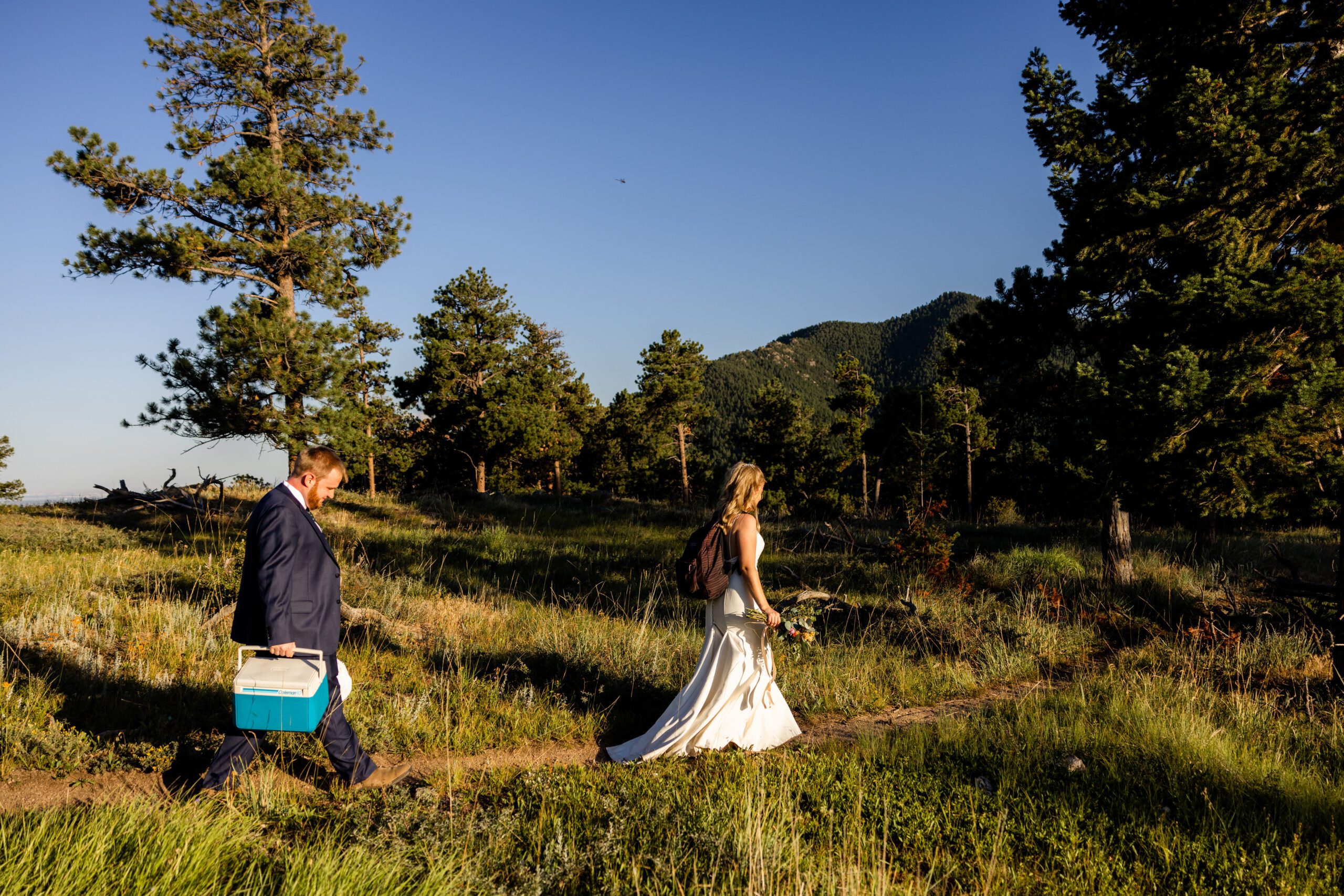 The bride and groom on their hike at sunset during their Sunrise Amphitheater wedding.