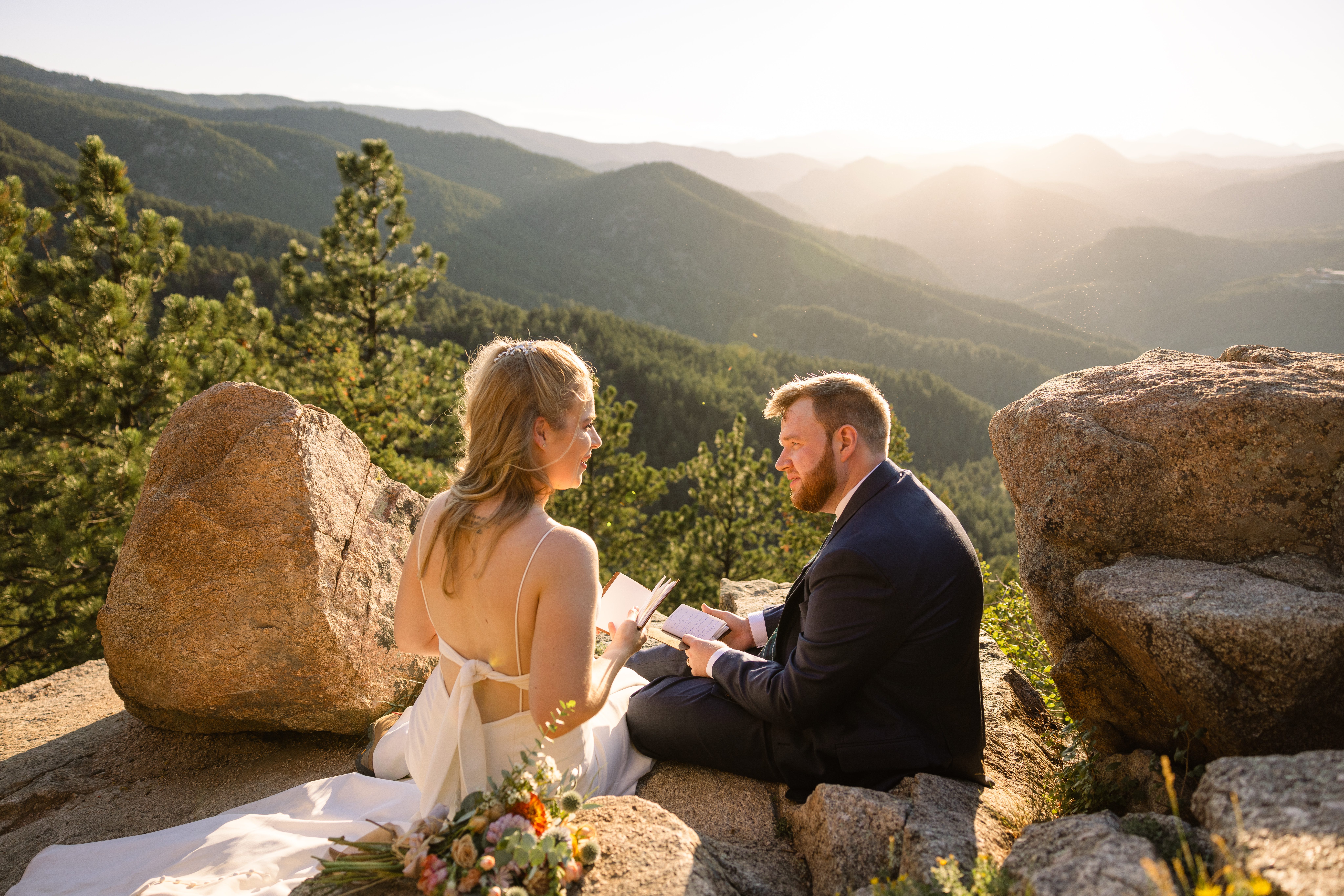 The bride and groom looking at each other during a moment on the mountain after their Sunrise Amphitheater wedding.