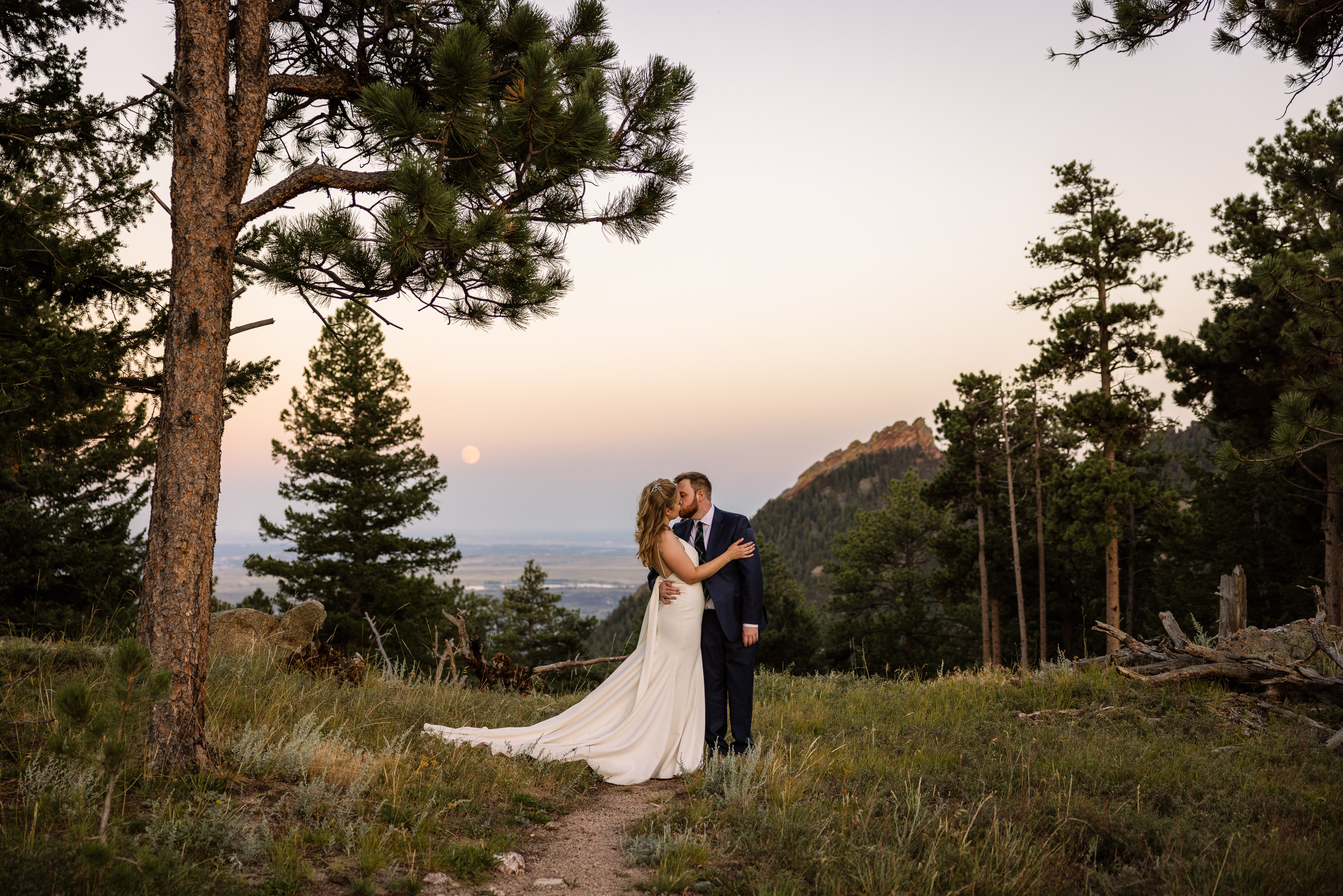 The bride and groom kissing at sunset, on their wedding day at Sunrise Amphitheater!
