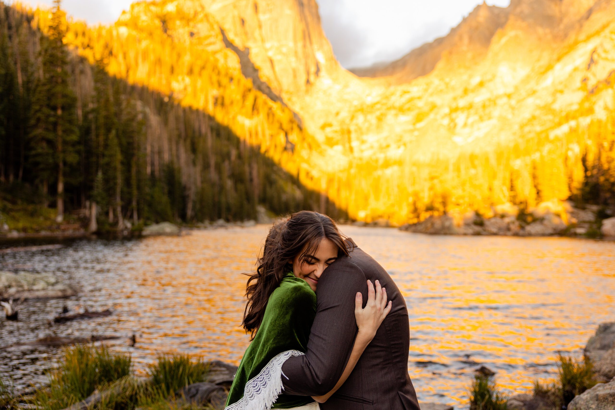 bride hugging groom hug tightly before their Dream Lake elopement, after their first look. 