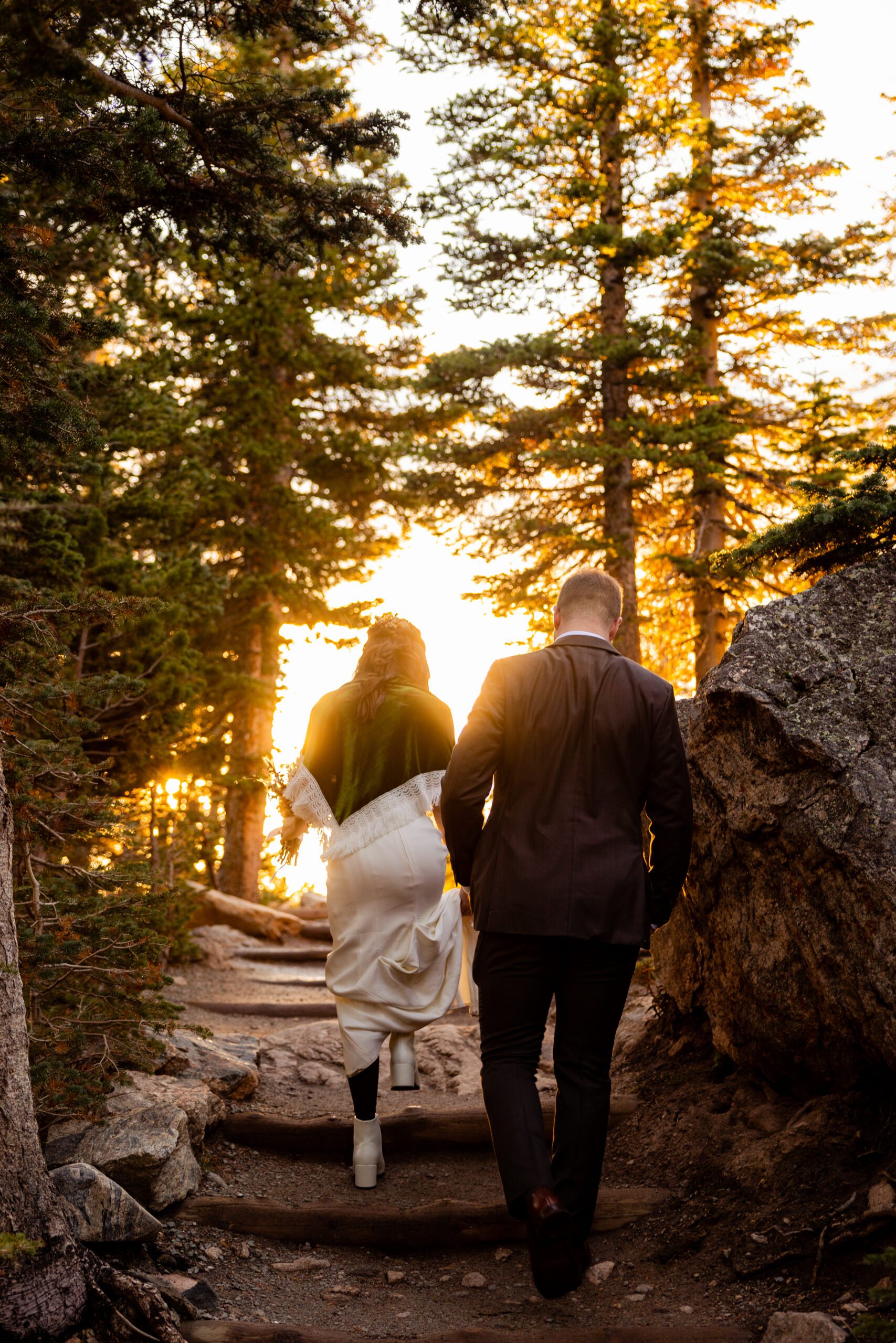 bride and groom hiking down the path to their first look at their Dream Lake elopement.
