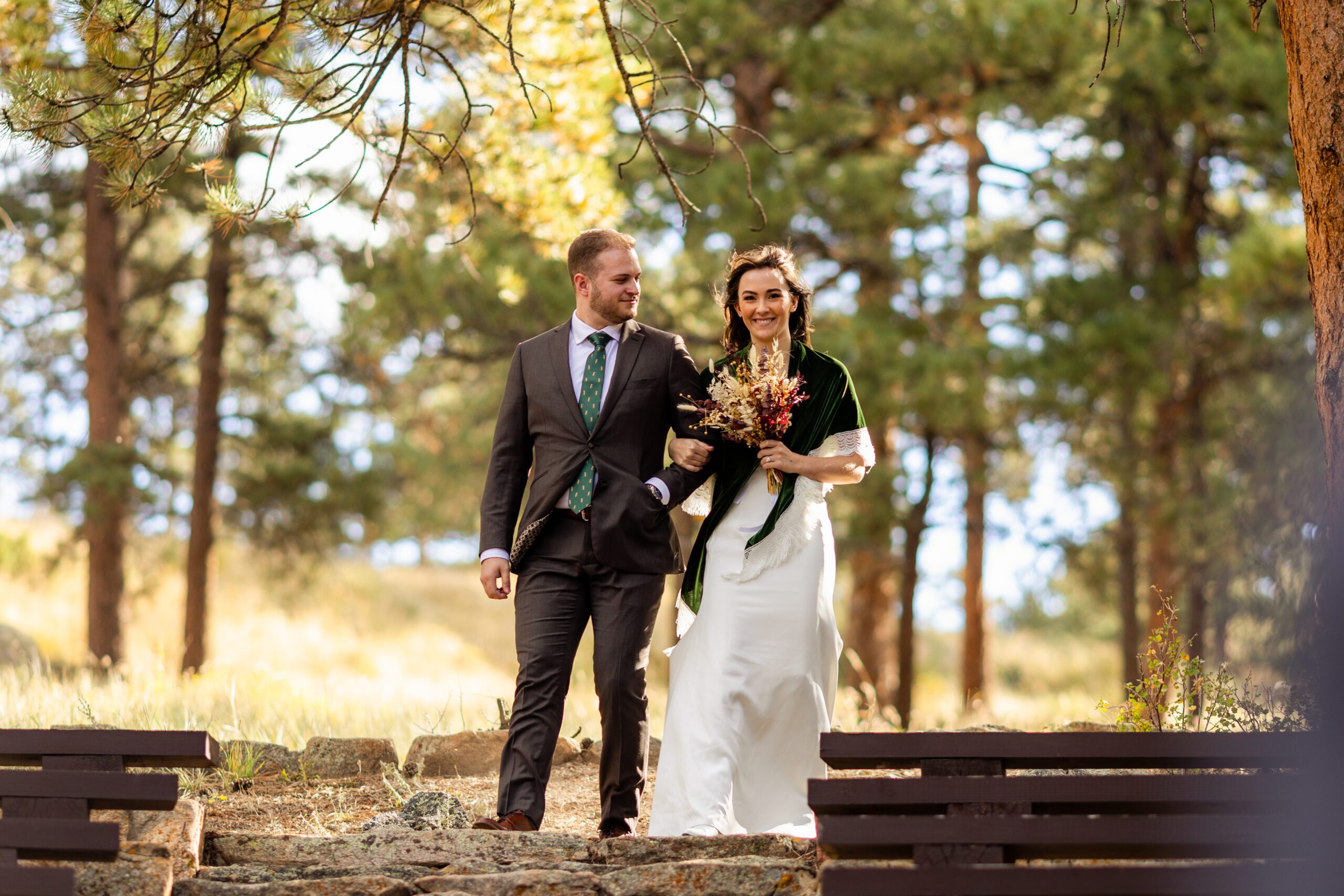 bride and groom walk down the aisle together at their Dream Lake elopement. 