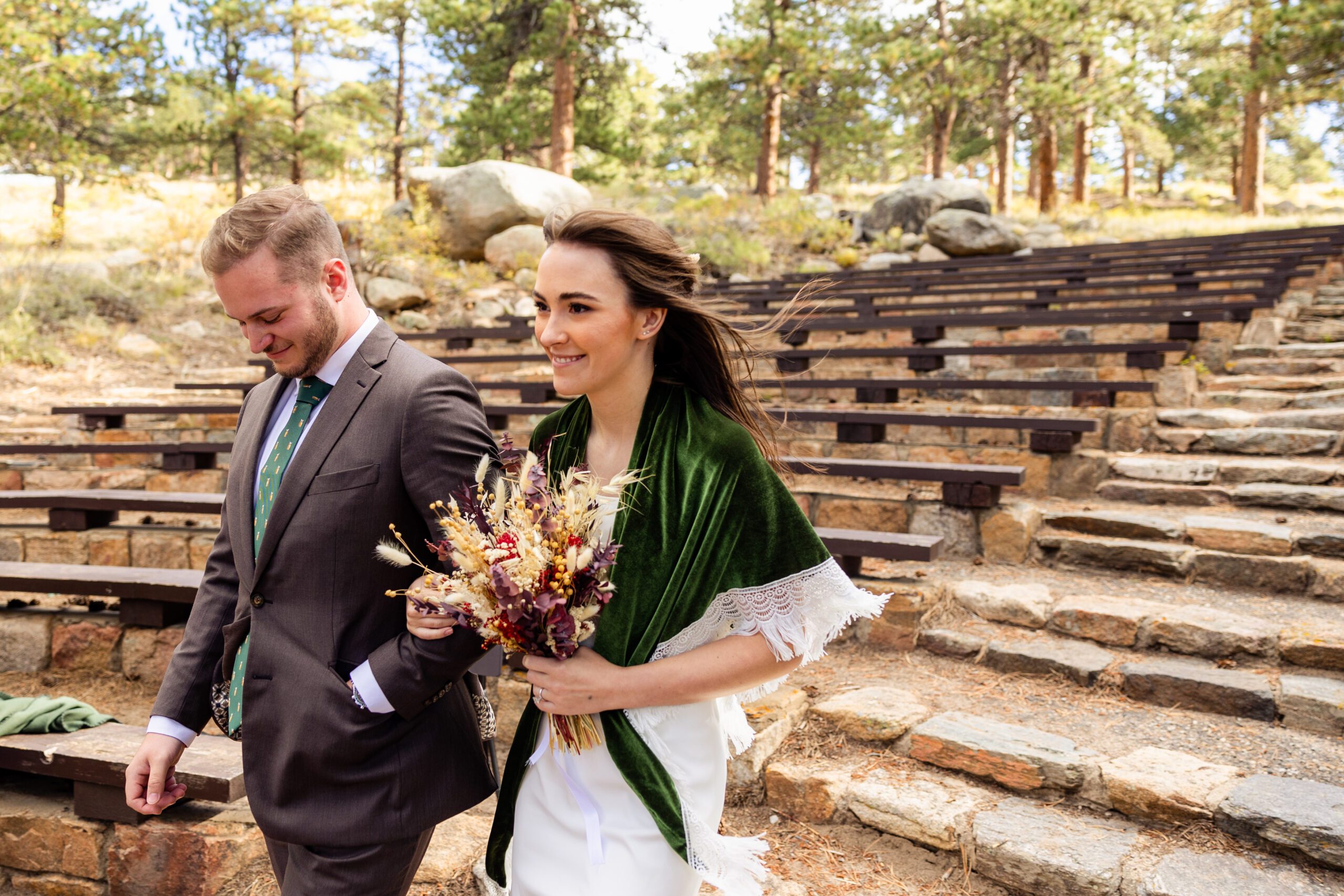 bride smiling as she walks down the aisle at her Dream Lake elopement. 