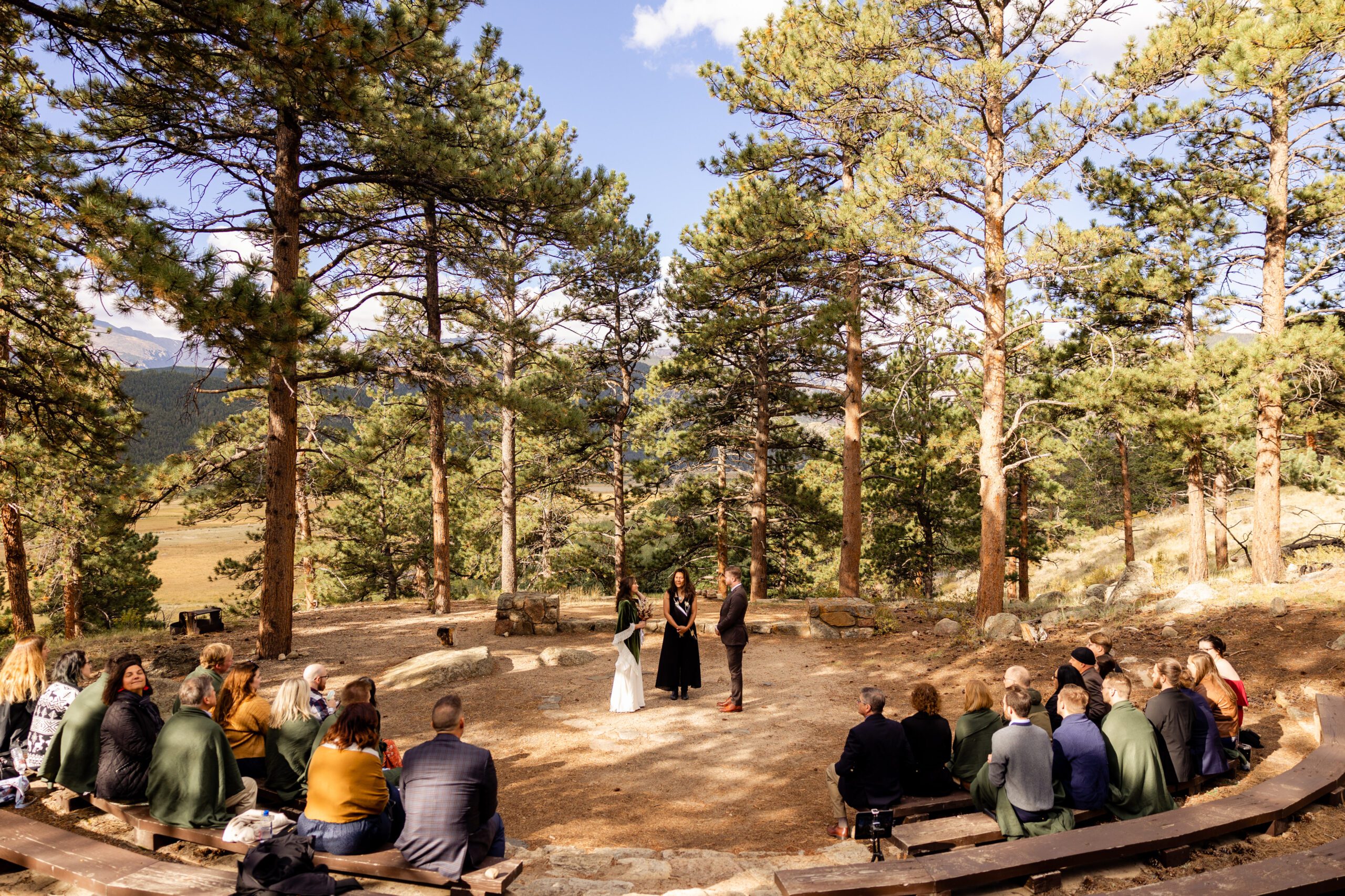 bride and groom standing in front of their guests at their Dream Lake elopement ceremony. 