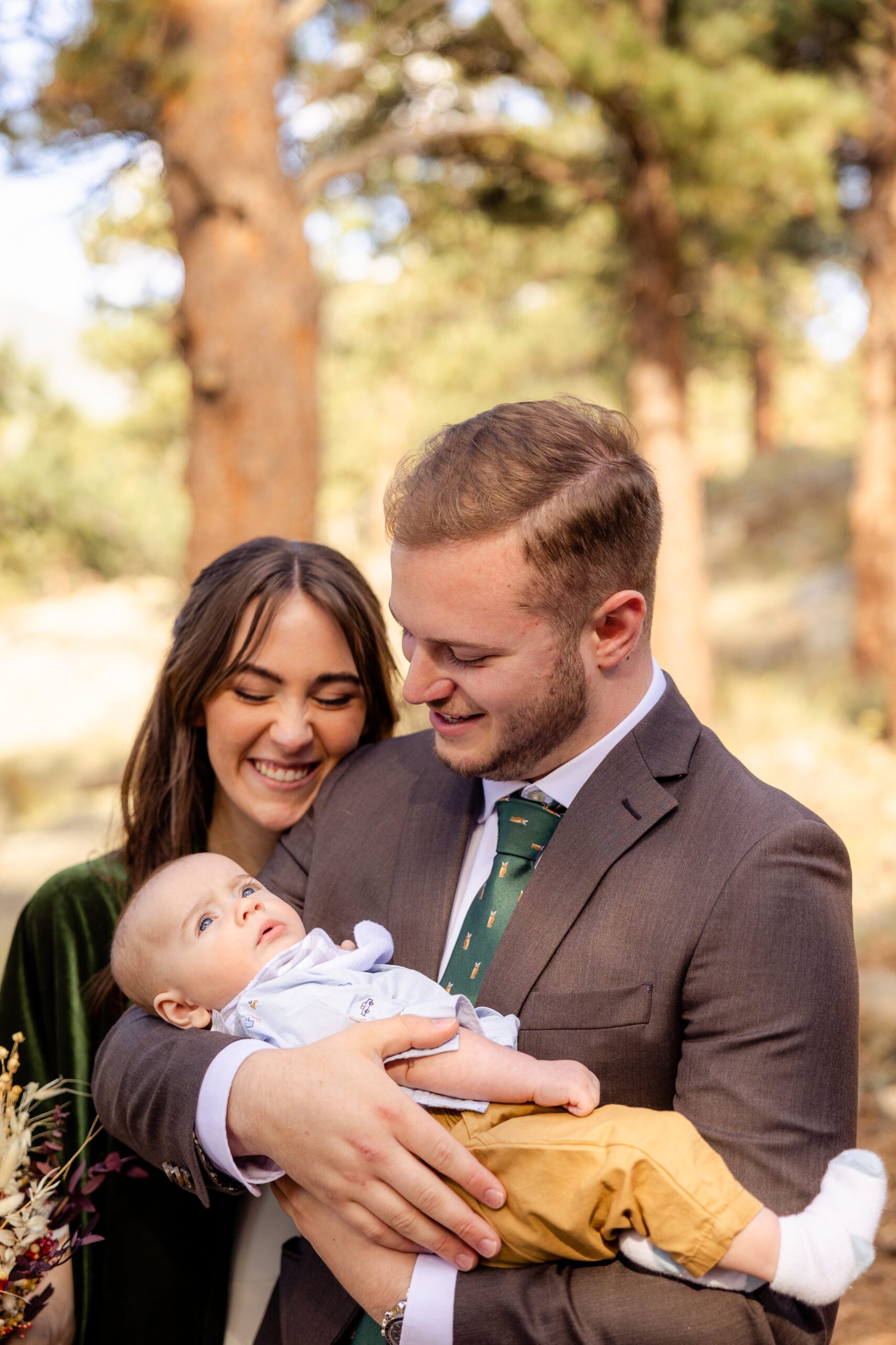 bride and groom with a little baby after their Dream Lake elopement ceremony. 