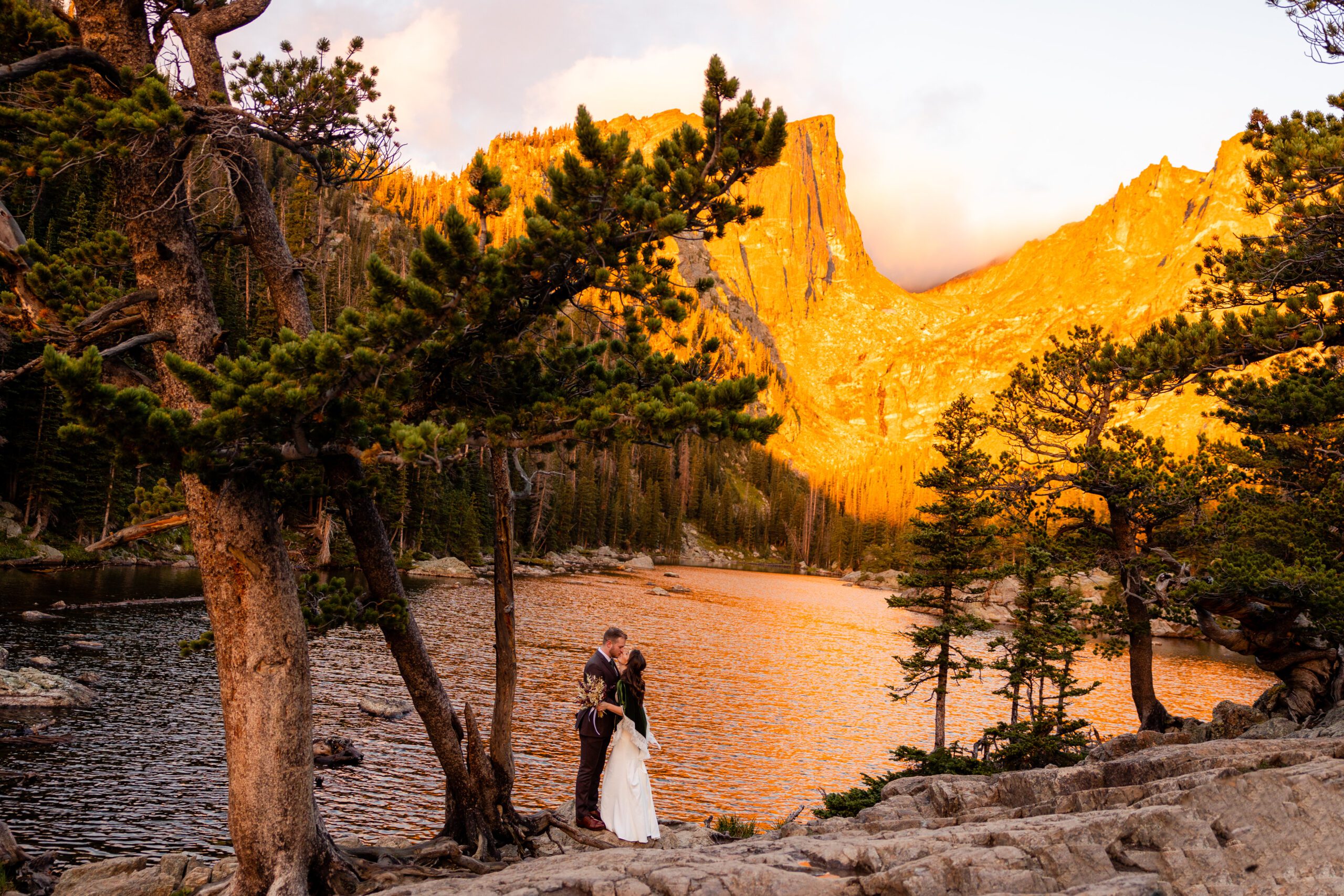 bride and groom smiling at each other, holding each other close at their Dream Lake elopement. 