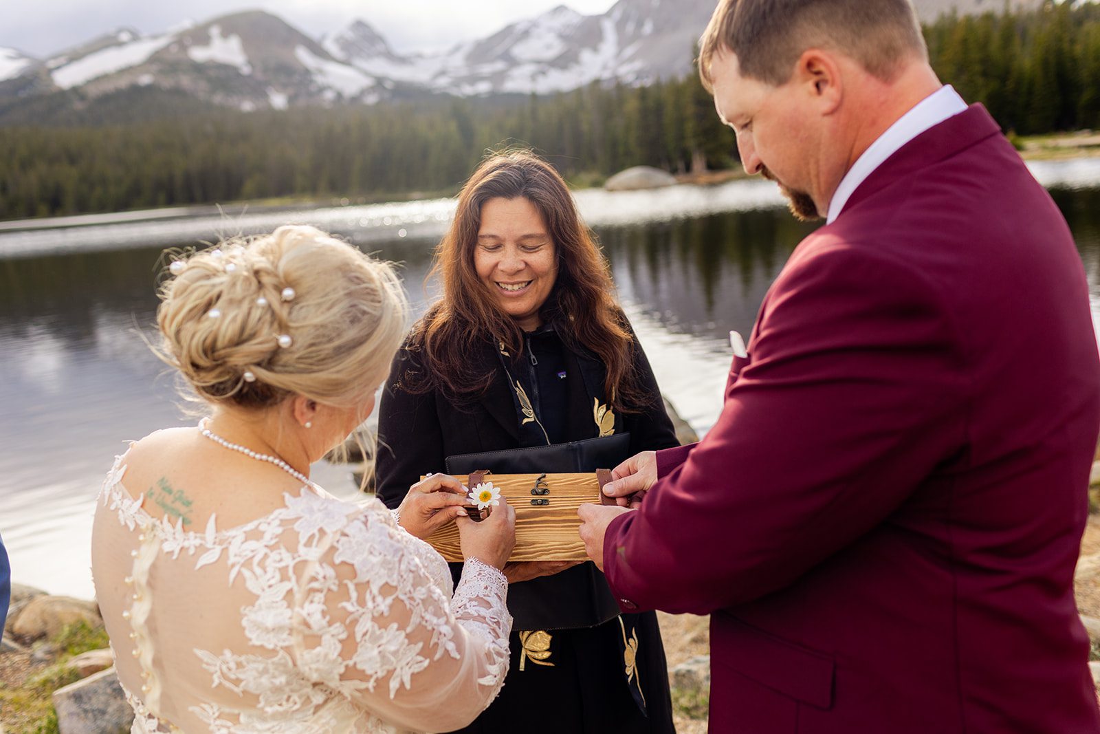 bride and groom during their ceremony with ring box at Brainard Lake