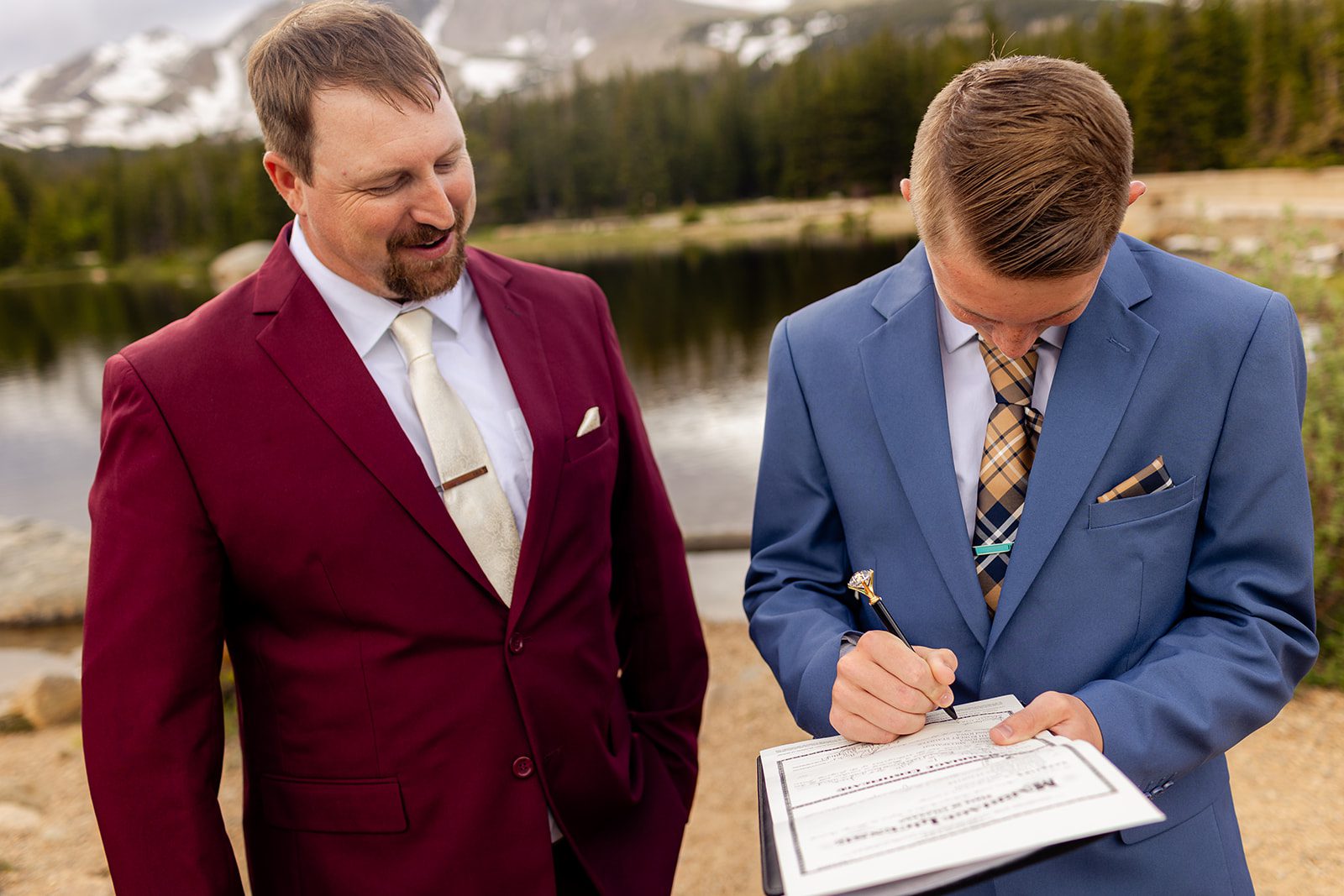 Groom and his son, son signs the marriage license.