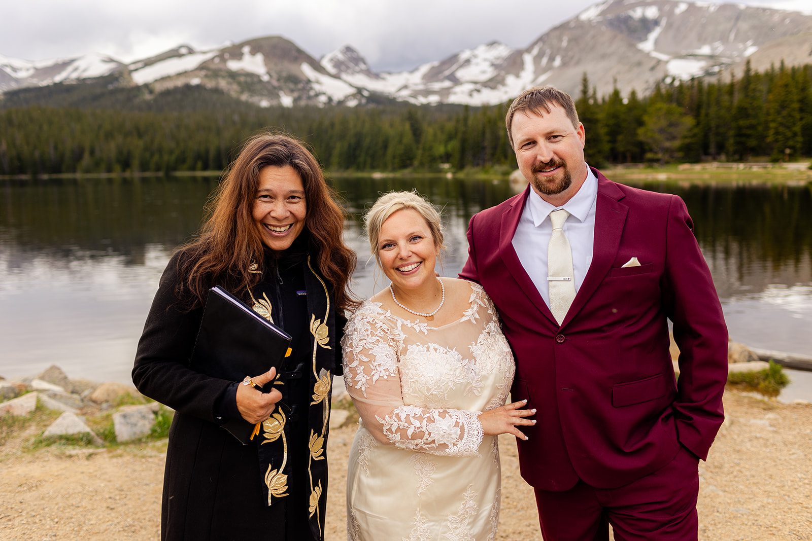 Bride, groom, and their officiant, at Brainard Lake after their wedding ceremony.