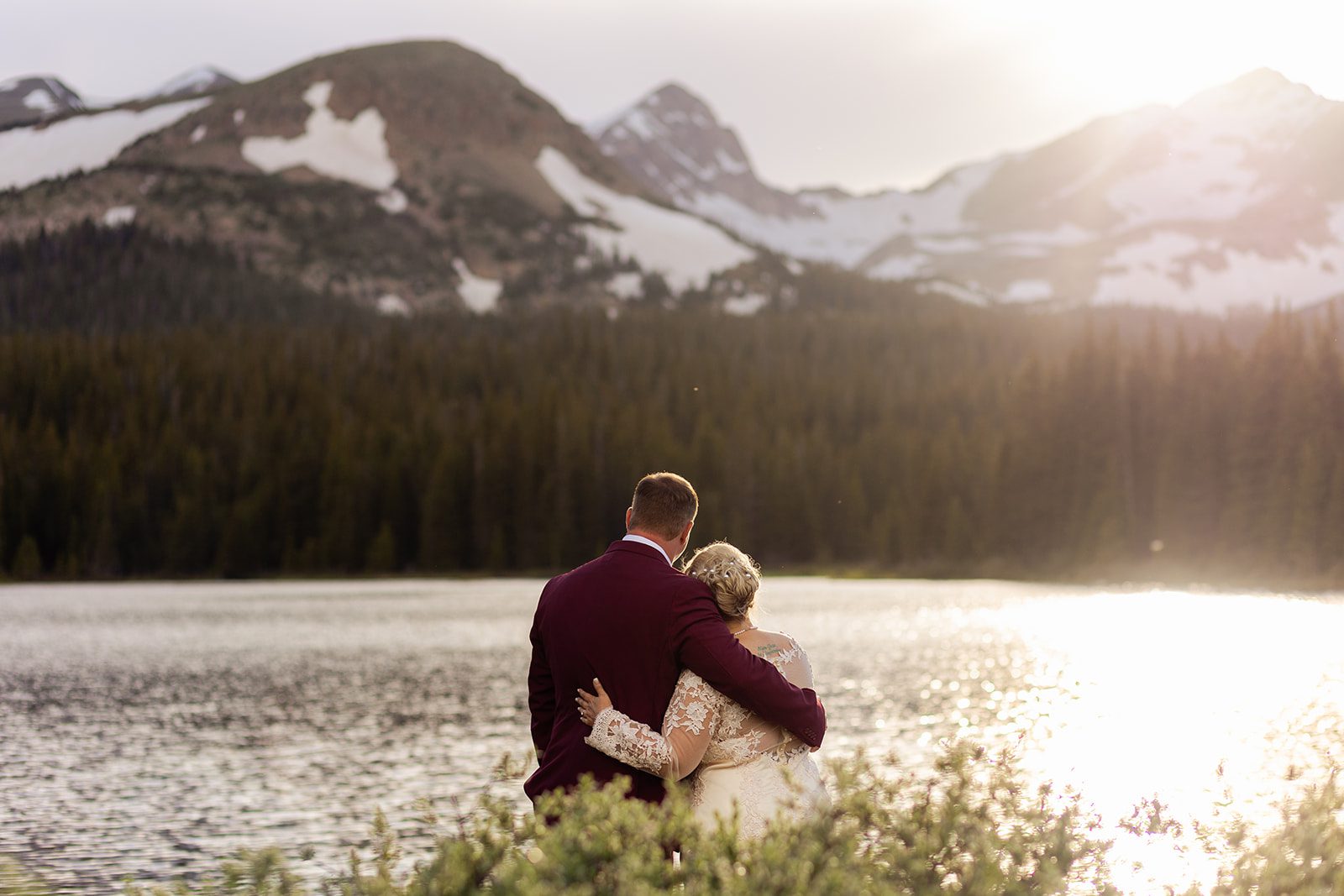 bride and groom holding each other looking towards Brainard Lake.