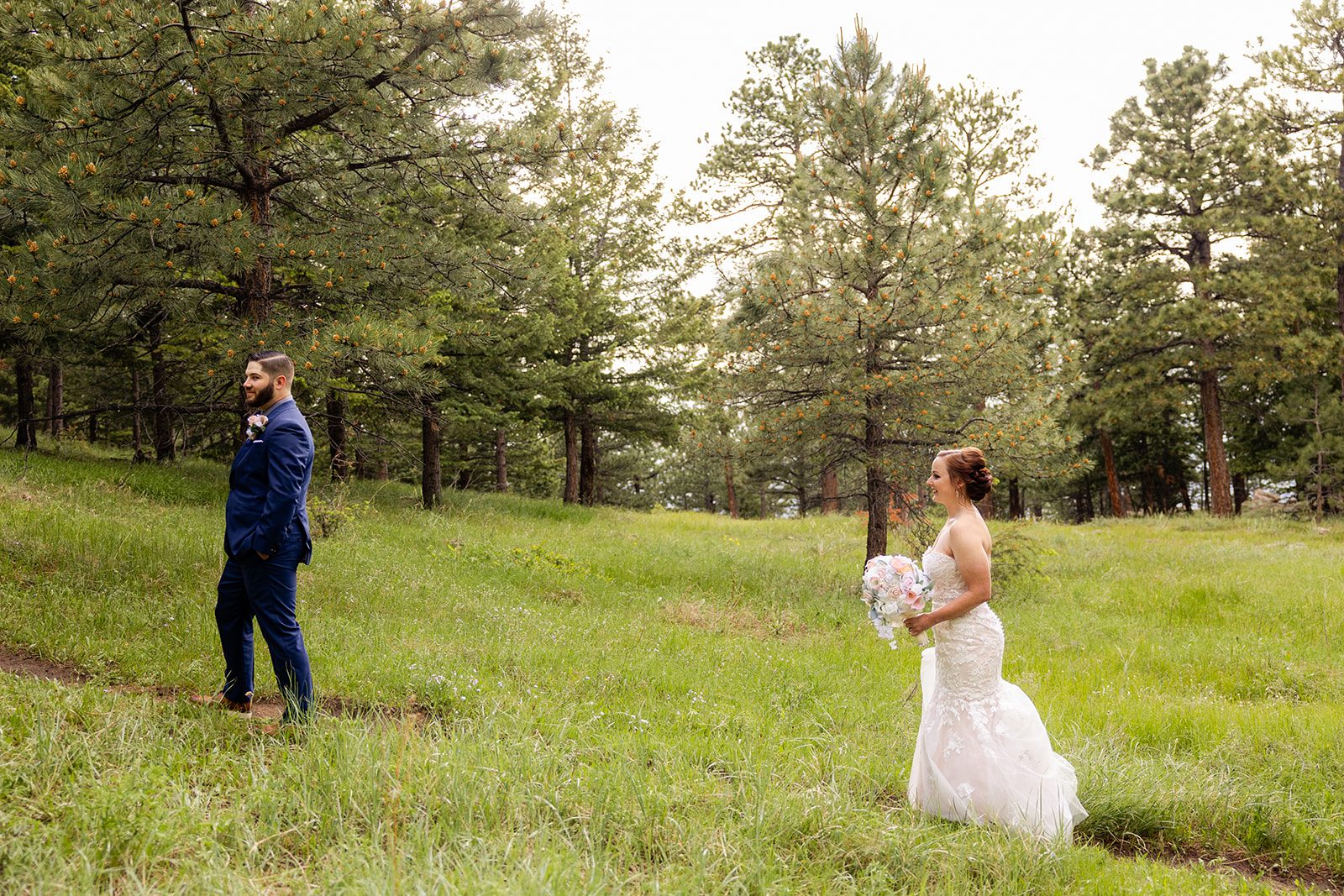 The bride and groom doing their first look a snapshot from their Boulder elopement with videography.