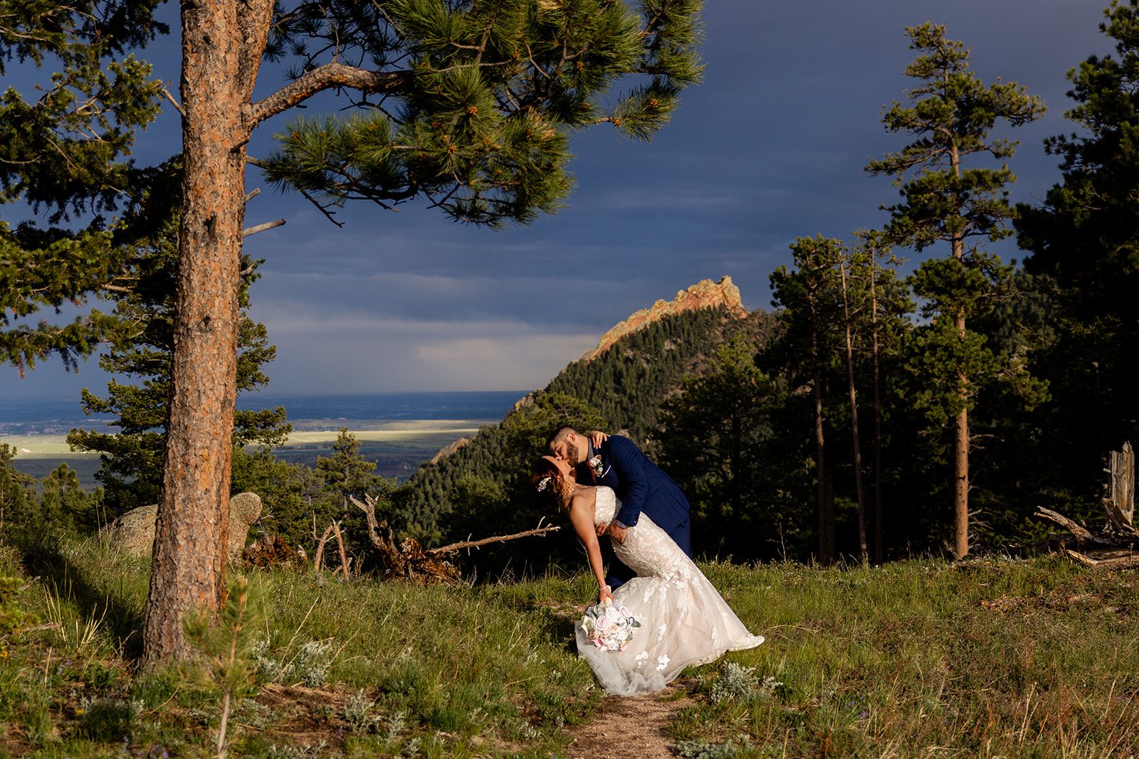 groom dips his bride down during  their Boulder elopement with videography.