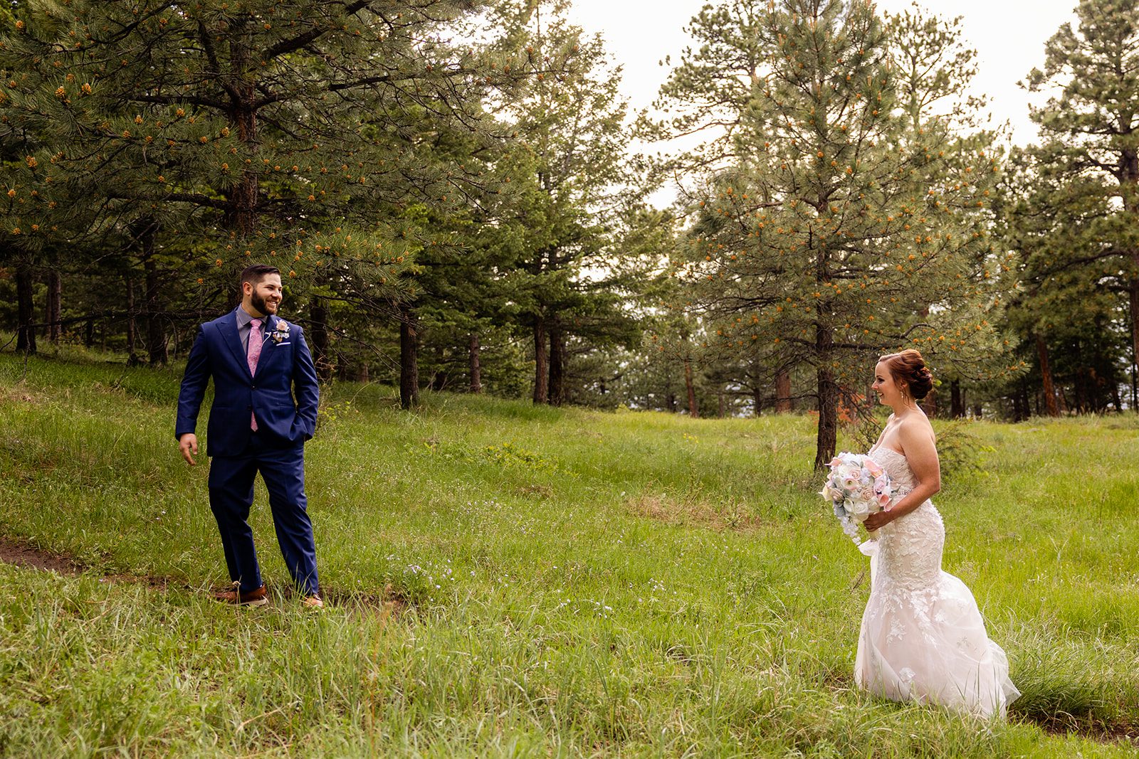 Groom turns to see his bride for their first look during their Boulder elopement with videography.
