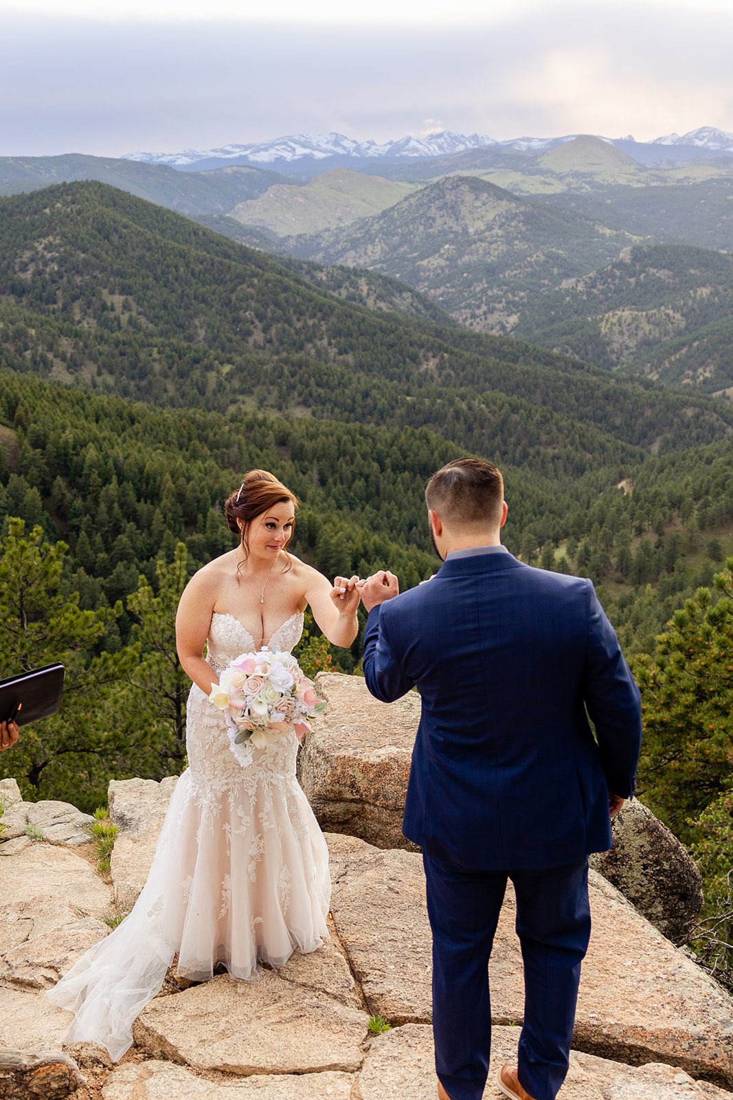 bride and groom doing a pinky promises during their Boulder elopement with videography.