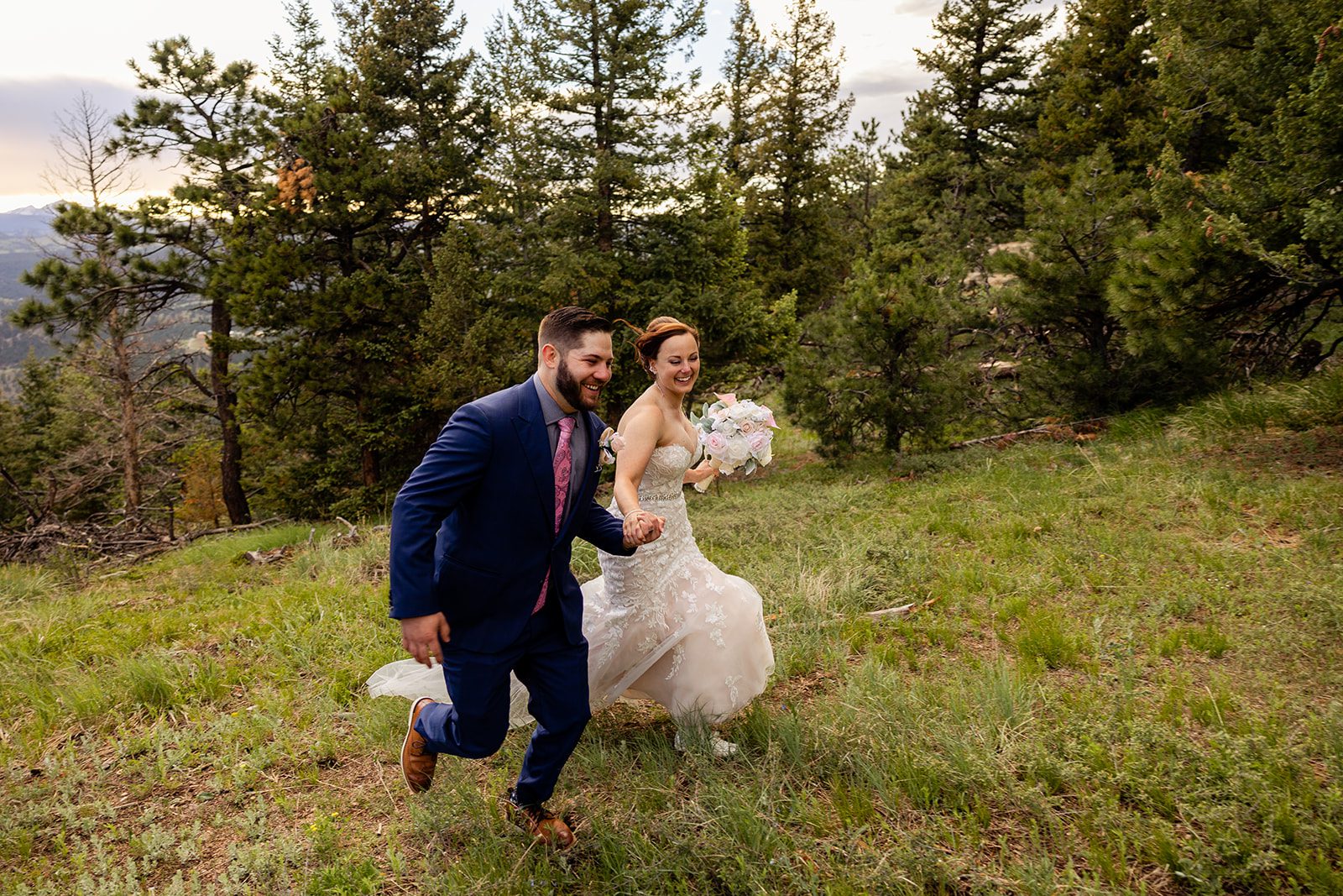 bride and groom running together holding hands, during  their Boulder elopement with videography.