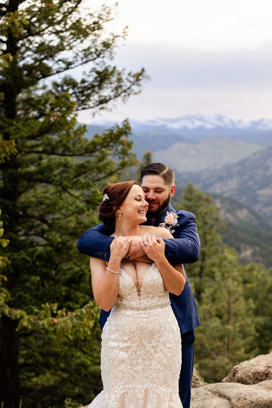 groom wraps his arms around his bride at their Boulder elopement with videography.