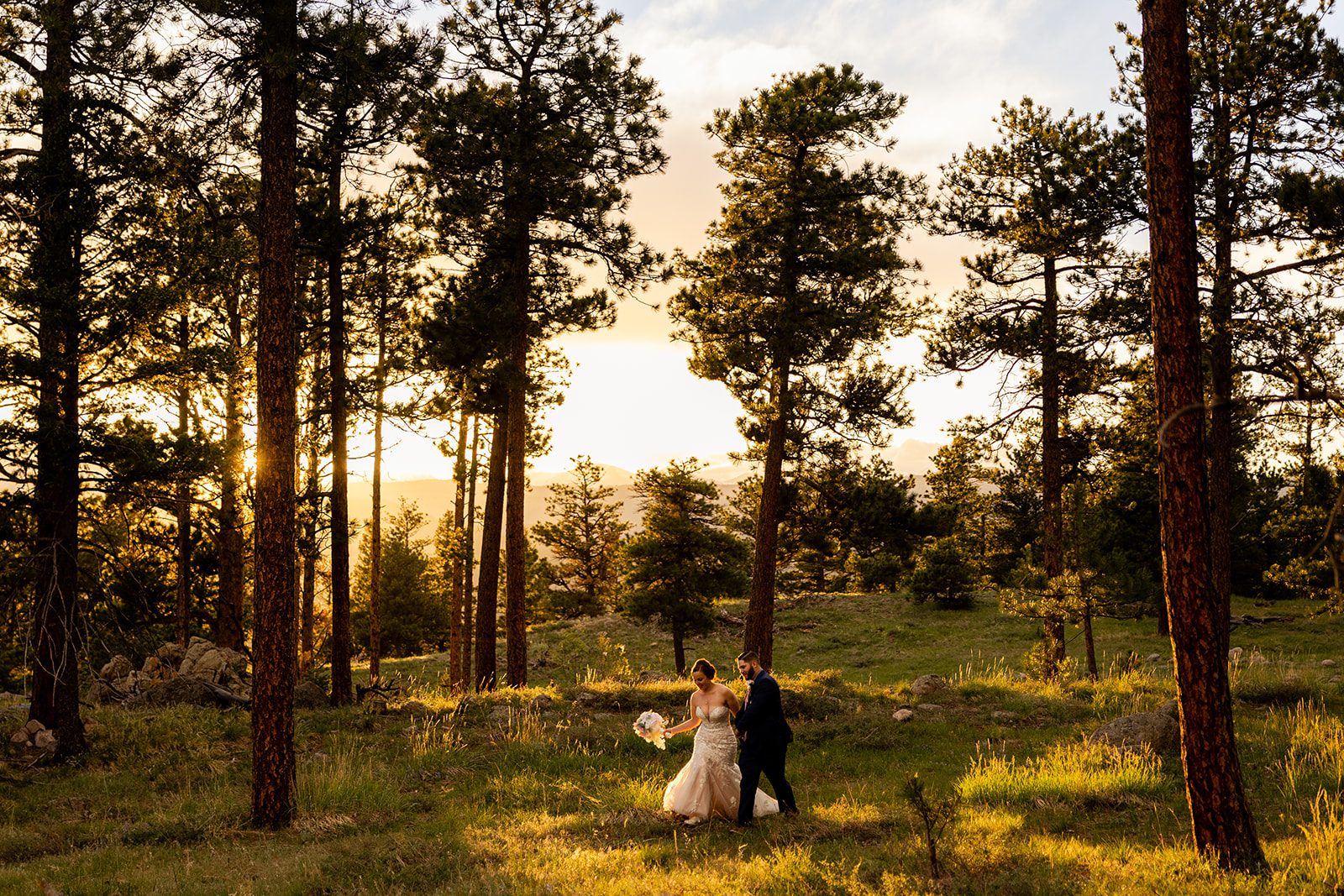 The bride and groom walking together during sunset at  their Boulder elopement with videography.