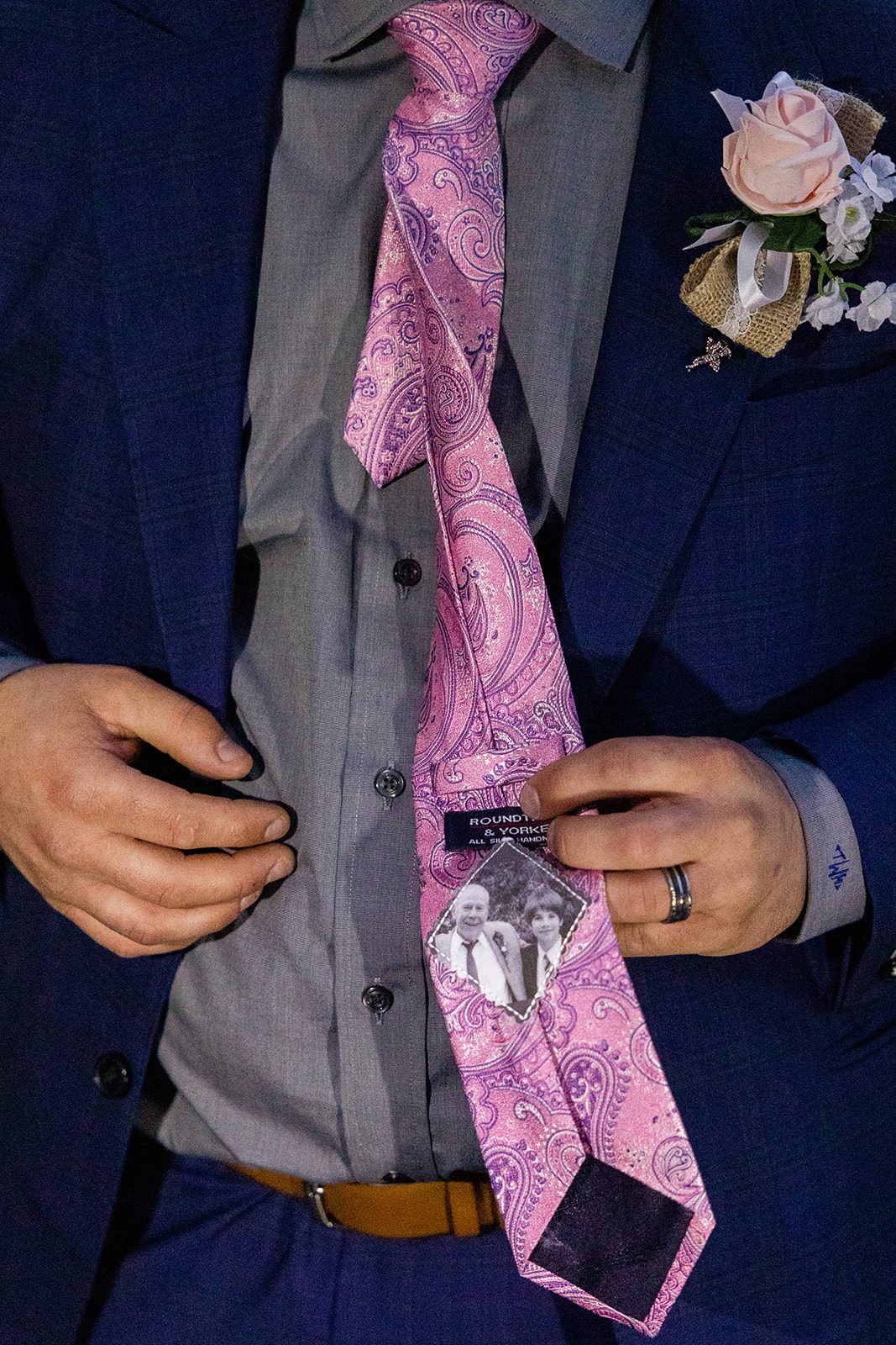 Grooms tie with a photo of his family member sewn in during their Boulder elopement with videography.